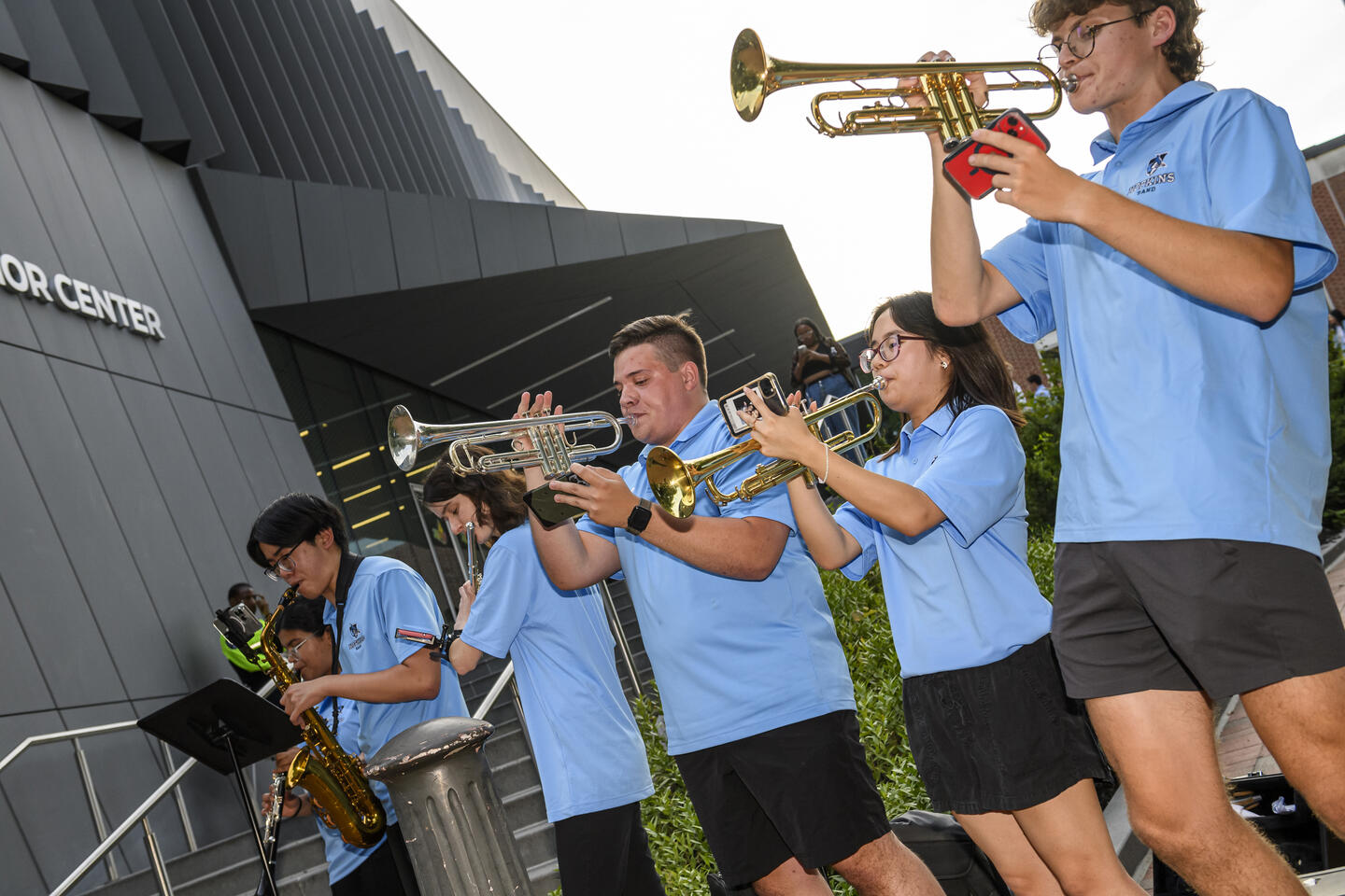 A pep band plays horns outside the rec center at Convocation 2024