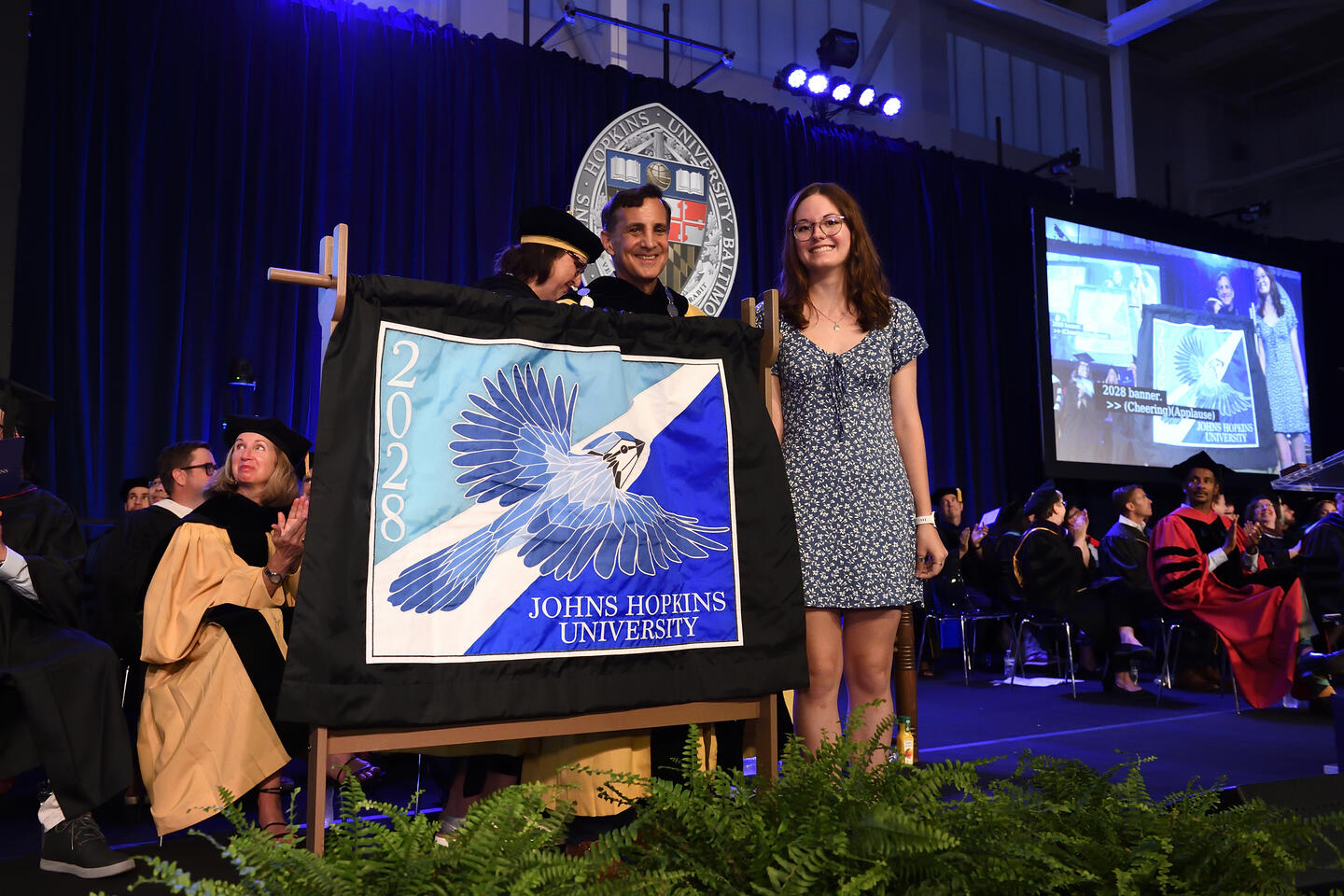 Sydnor Duffy, winner of the Class of 2028 banner contest, with President Daniels at Convocation 2024