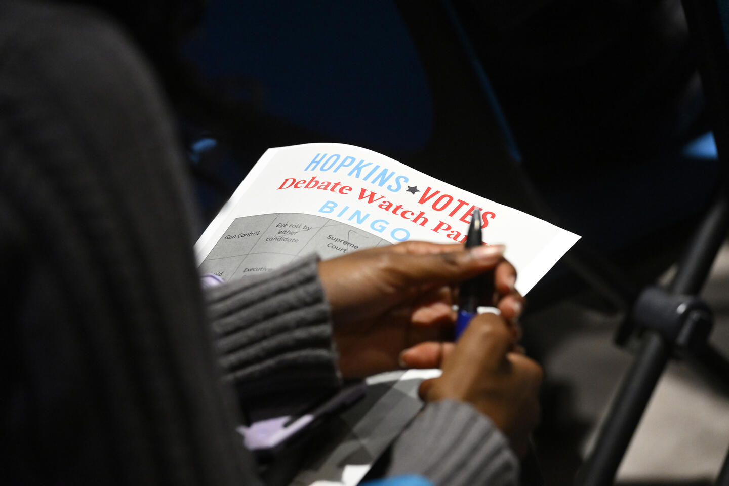 A Hopkins Voted debate watch party bingo card in a students hands