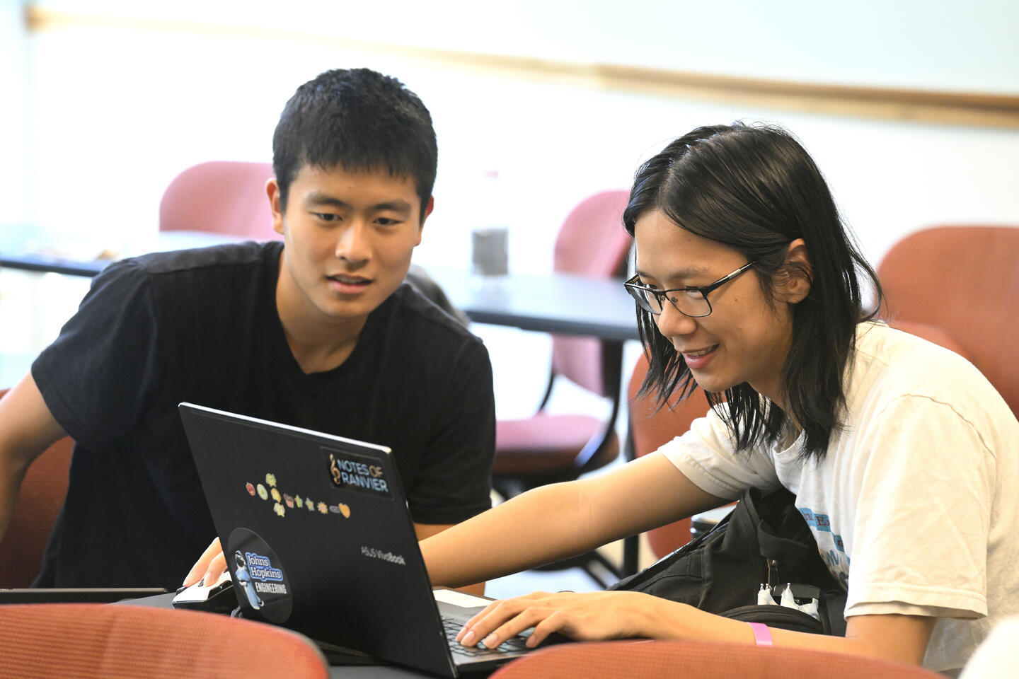 Students look at a laptop during HopHacks