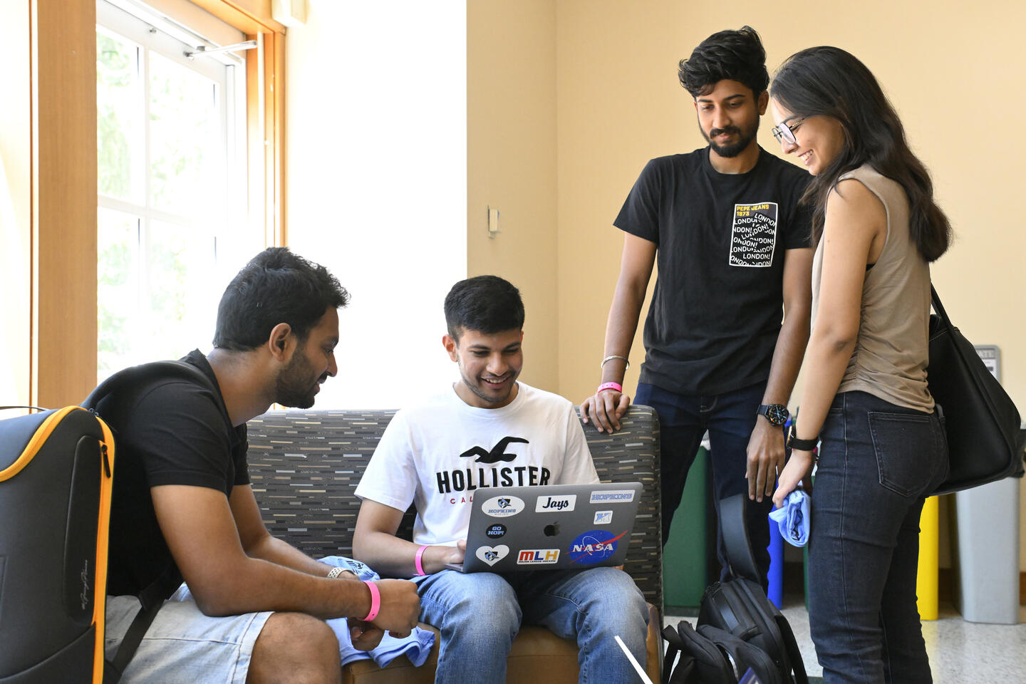 Students at HopHacks in a room lit with sunlight