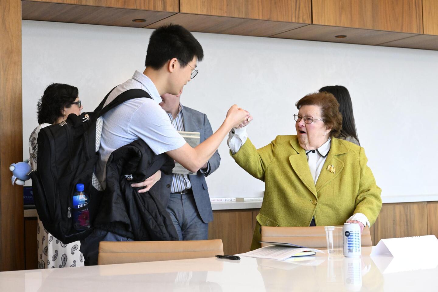 A college student fist bumps Barbara Mikulski