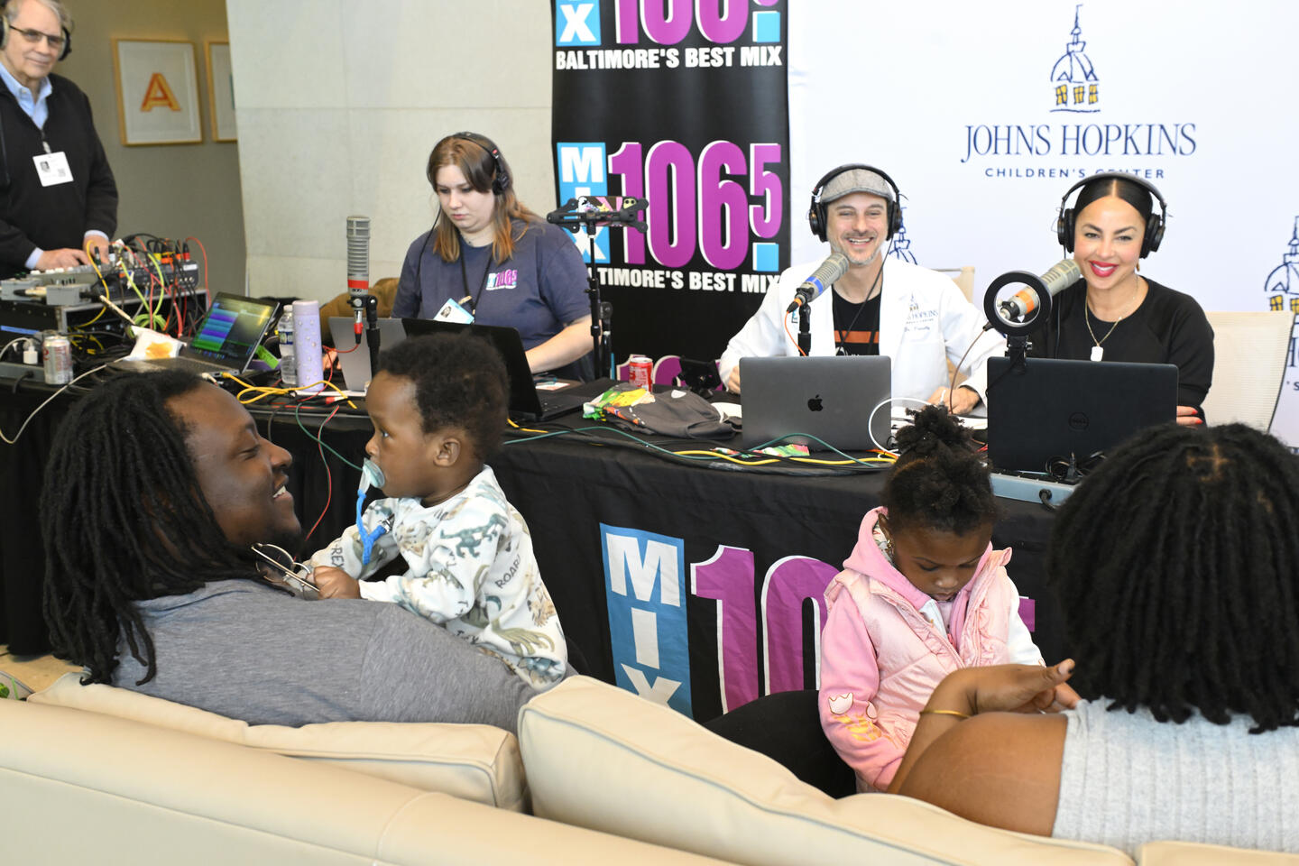 A family and Mix 106.5 DJs at the radiothon