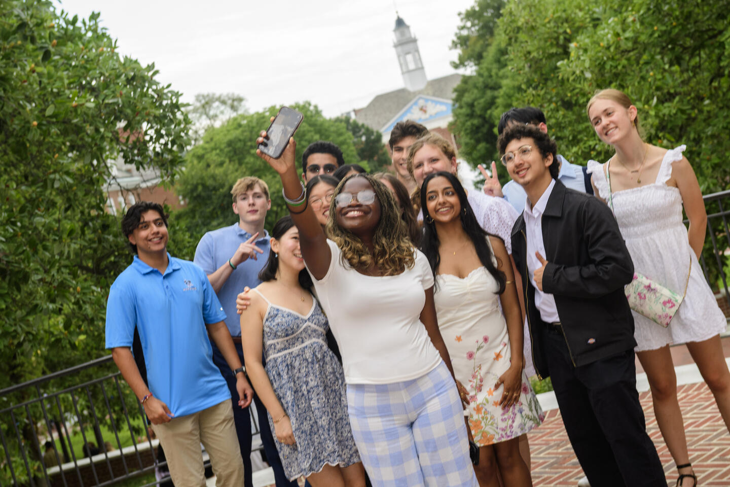 Students take a selfie with Gilman Hall in the background