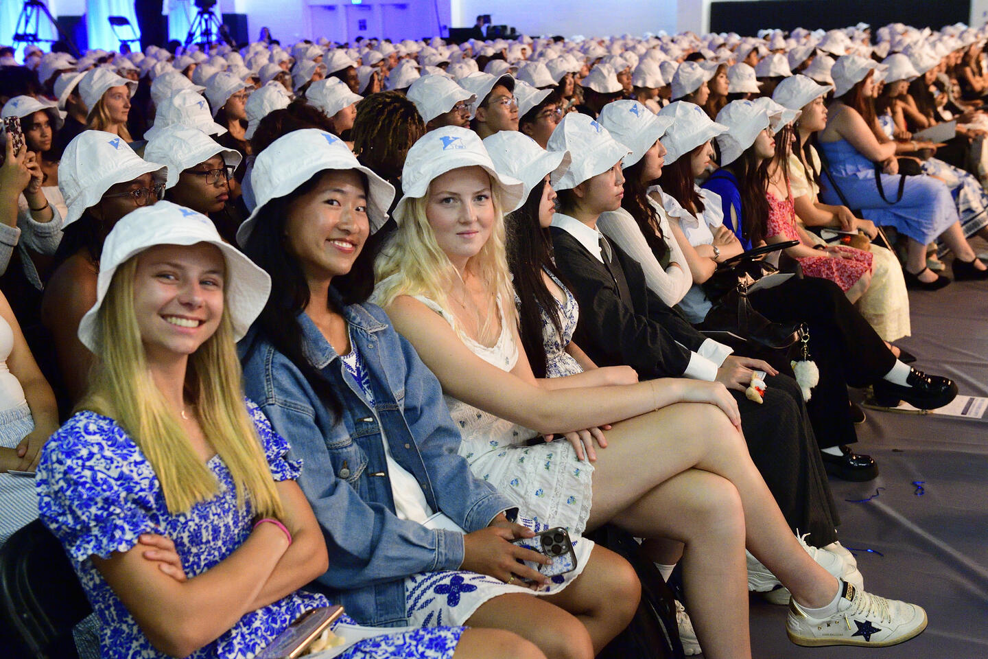 Students wearing bucket hats at convocation