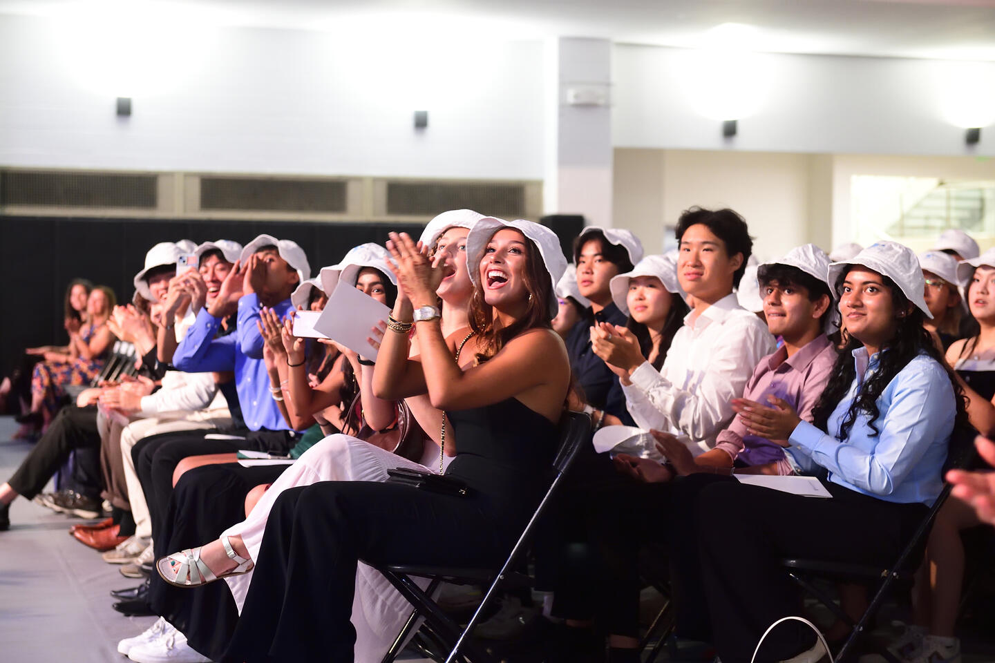 Students wearing bucket hats at Convocation