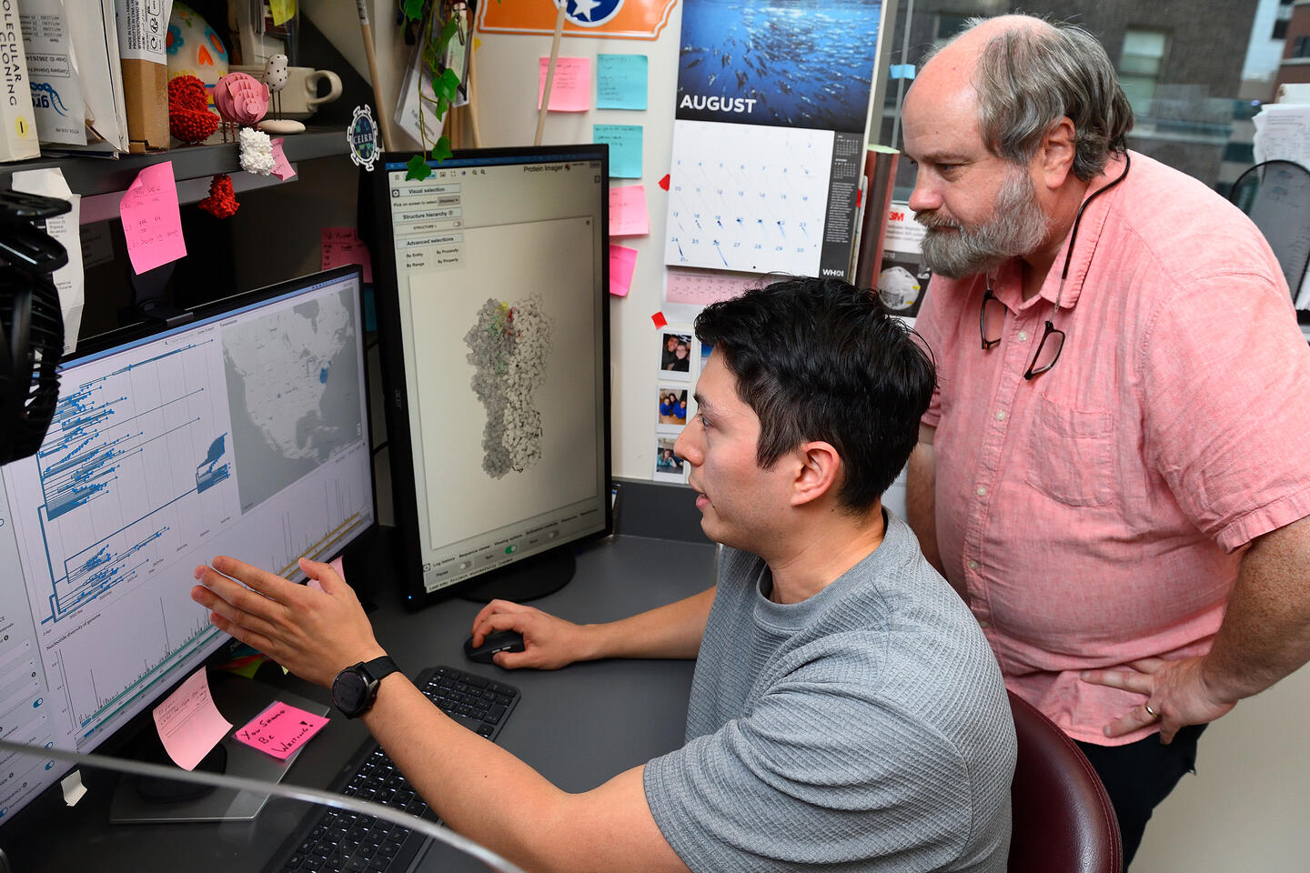 Two people look at data on computer screens