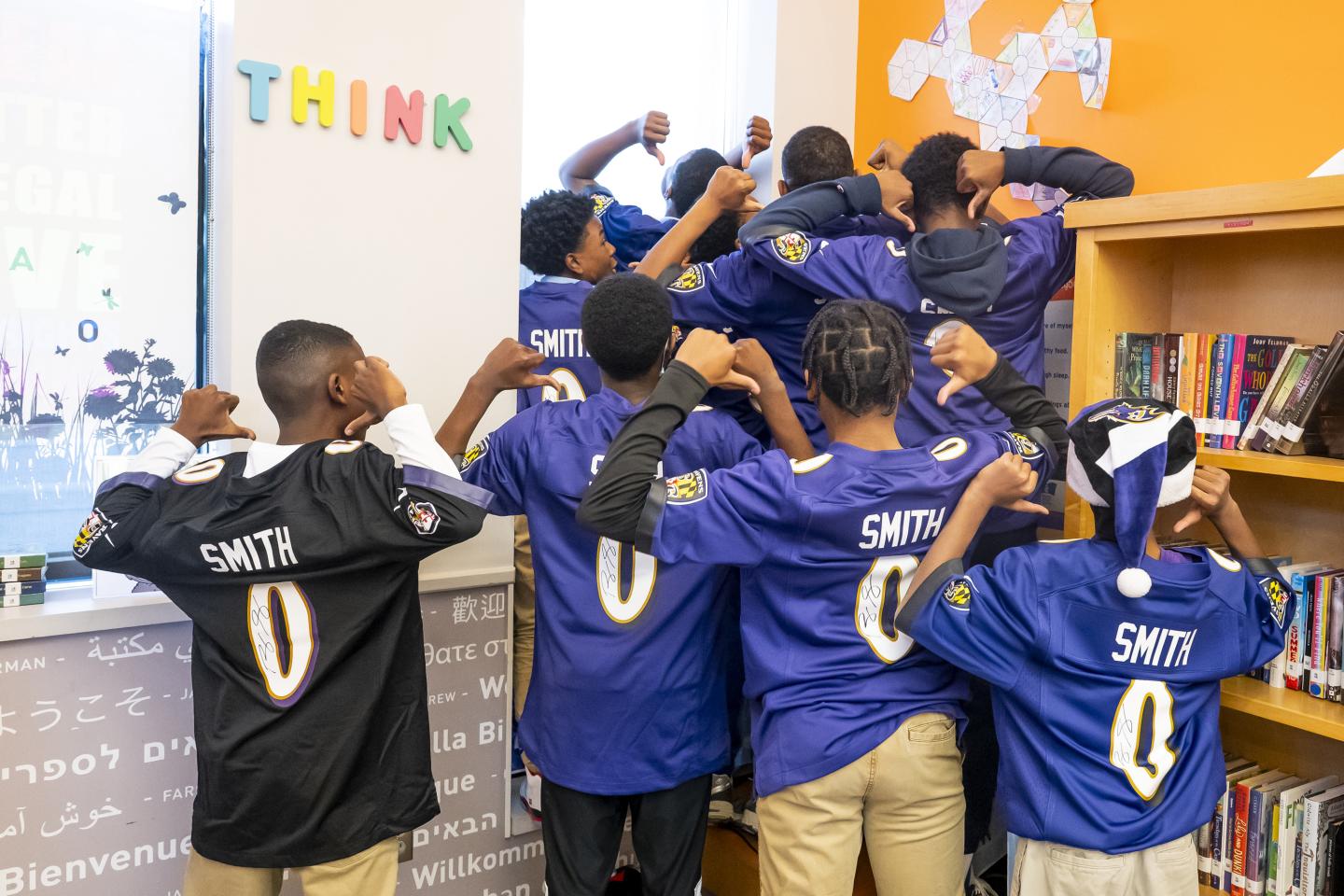 Students with their backs to the camera to show off their Roquan Smith jersey with his number on the back