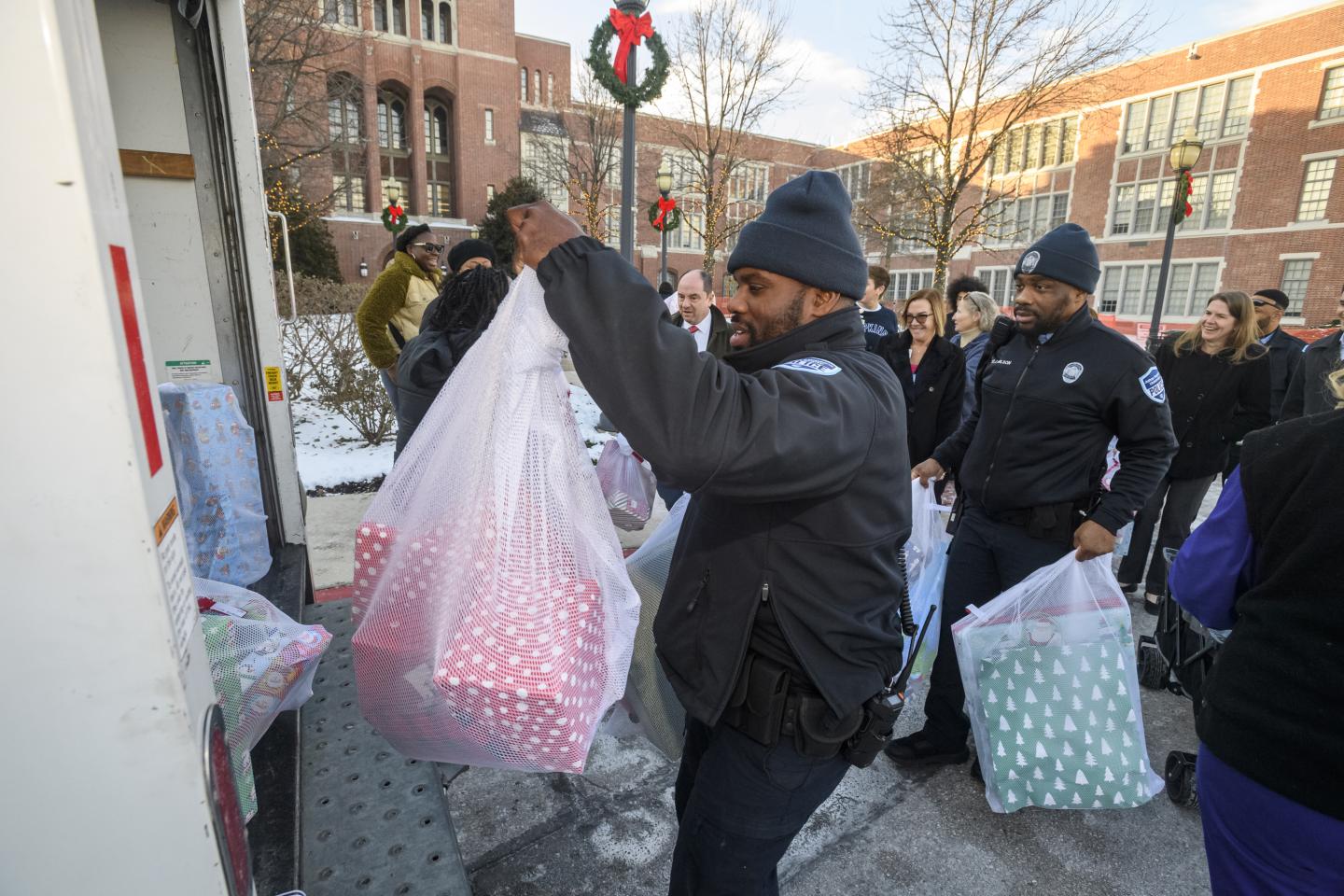 A Johns Hopkins affiliate carries bags of presents
