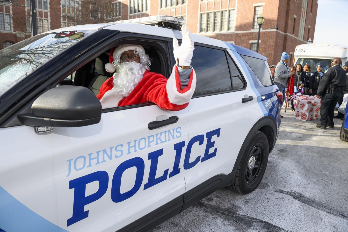 Santa waves while driving a JHPD vehicle