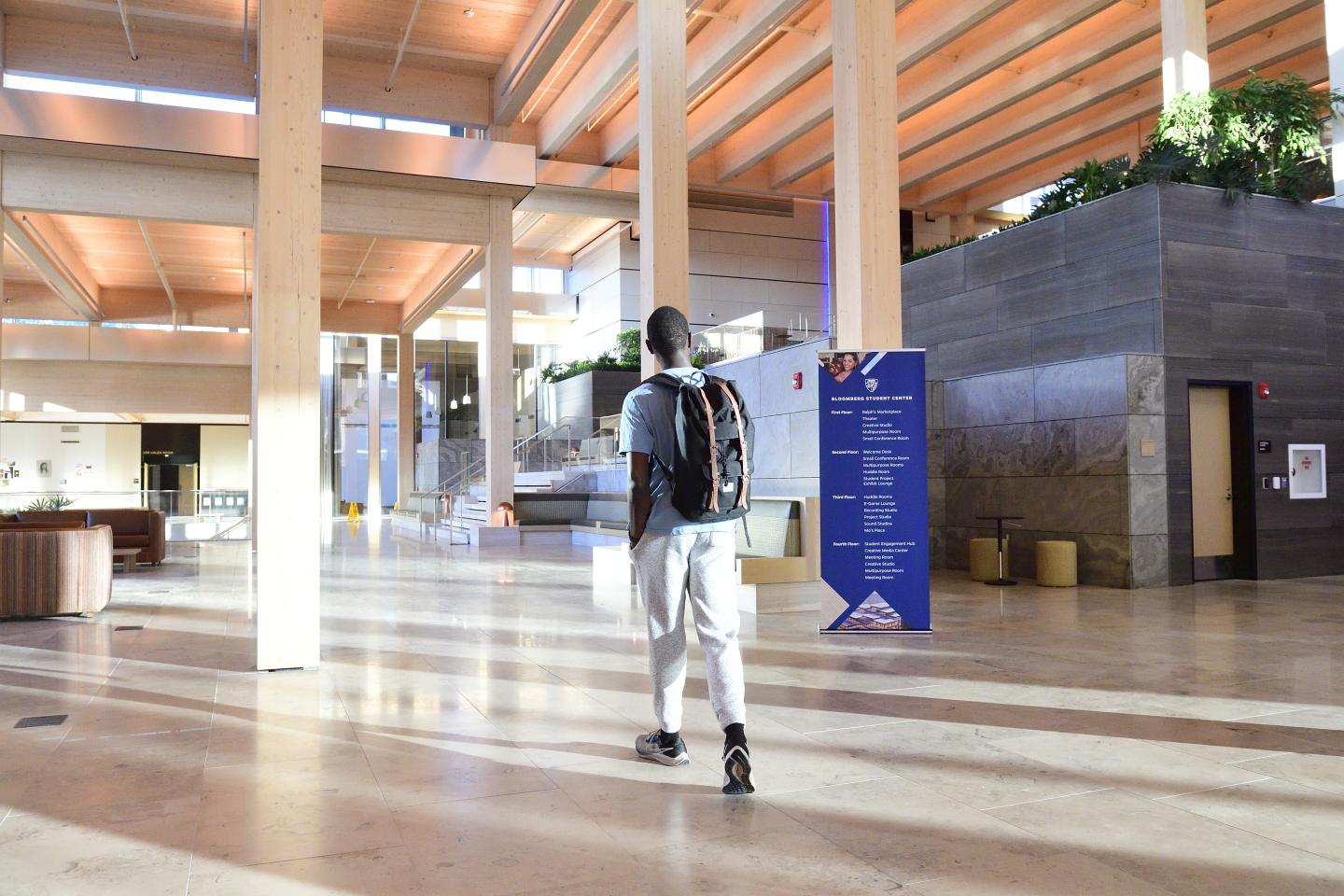 A student walks into the Bloomberg Student Center