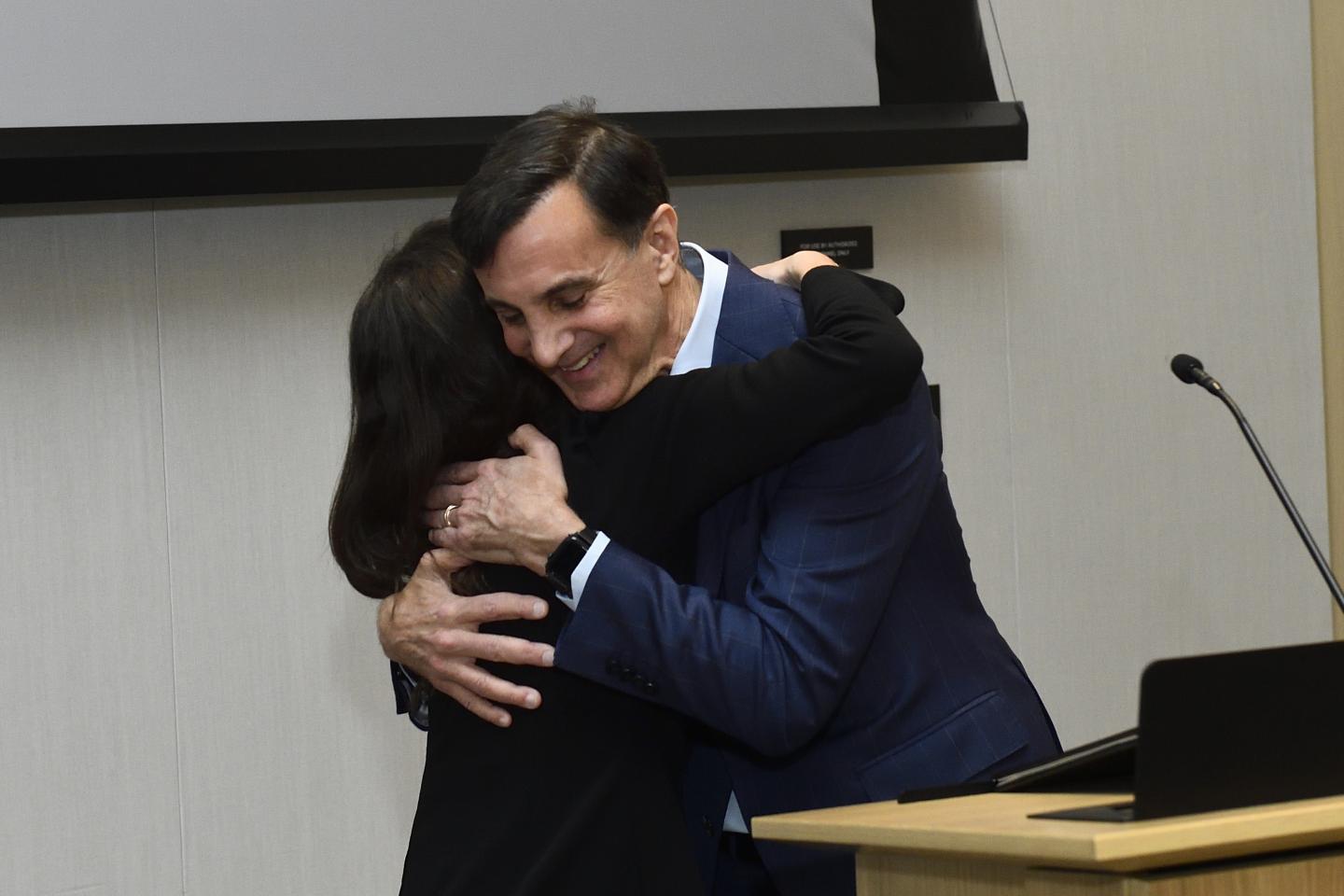Ron Daniels and Jamie Spangler hug in celebration.