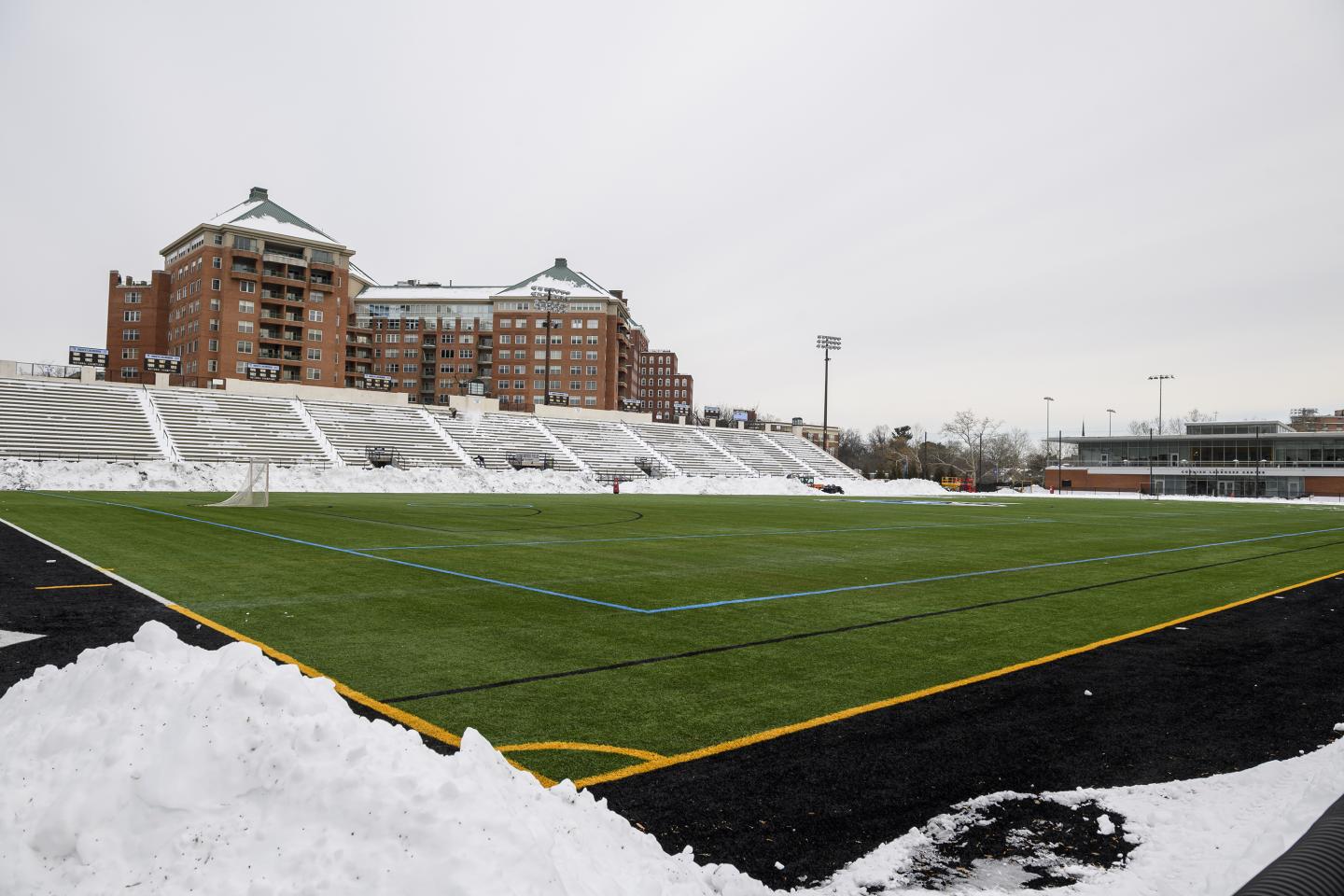 Homewood Field on a winter day, cleared of snow with snow piles around the edges