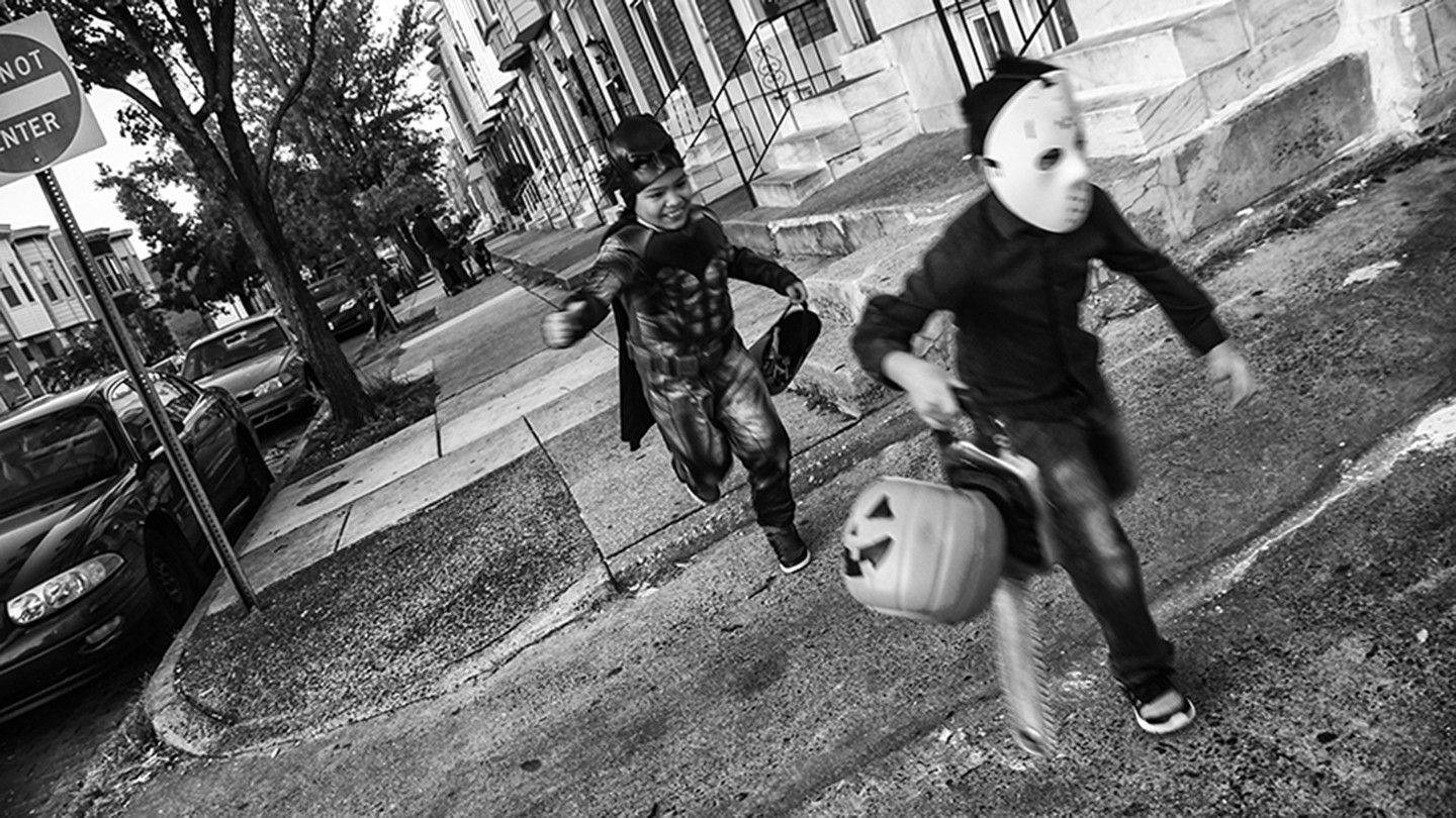 Two boys run in Halloween costumes Two boys run in Halloween costumes
