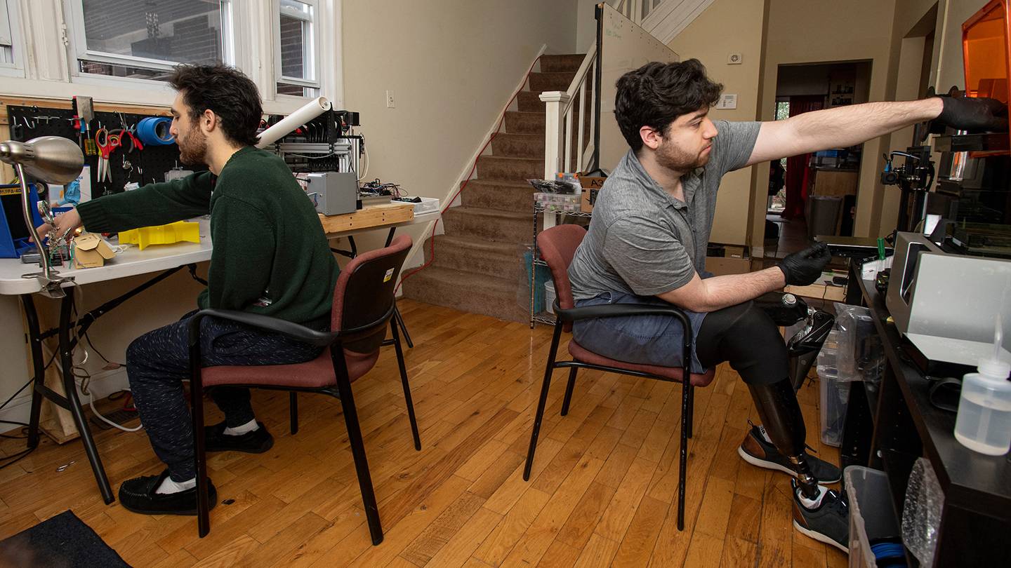 Mechanical Engineering undergraduate Mark Shifman and BME undergraduate Chris Shallal work in the makeshift engineering lab they set up in their home near campus with their housemates during the shutdown necessitated by the COVID-19 pandemic.