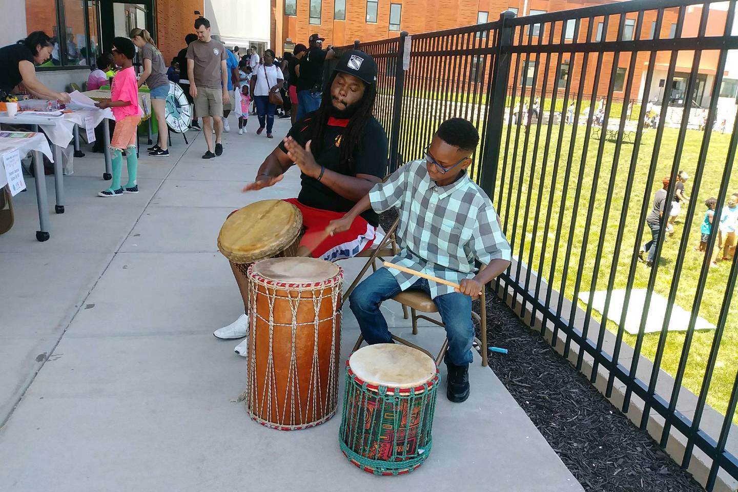 A little boy plays a drum