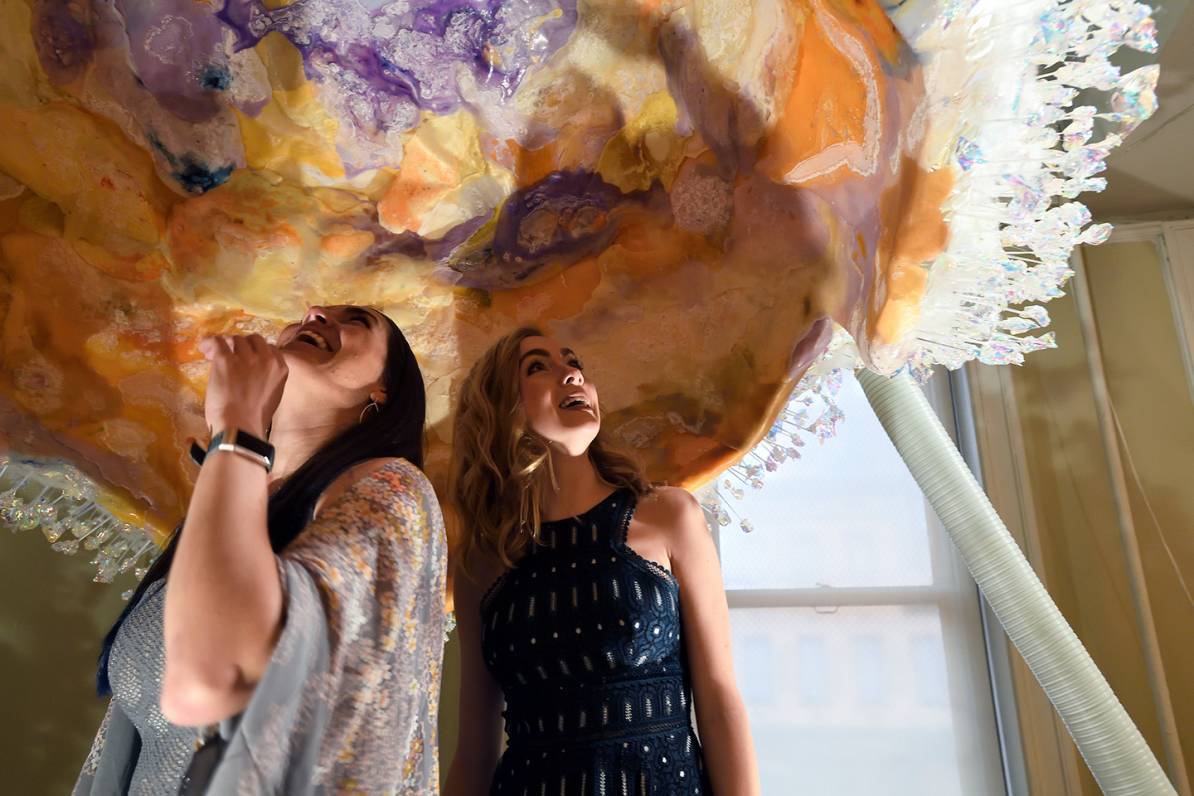 Sarah Hörst and Amy Wetsch stand inside a sculpture