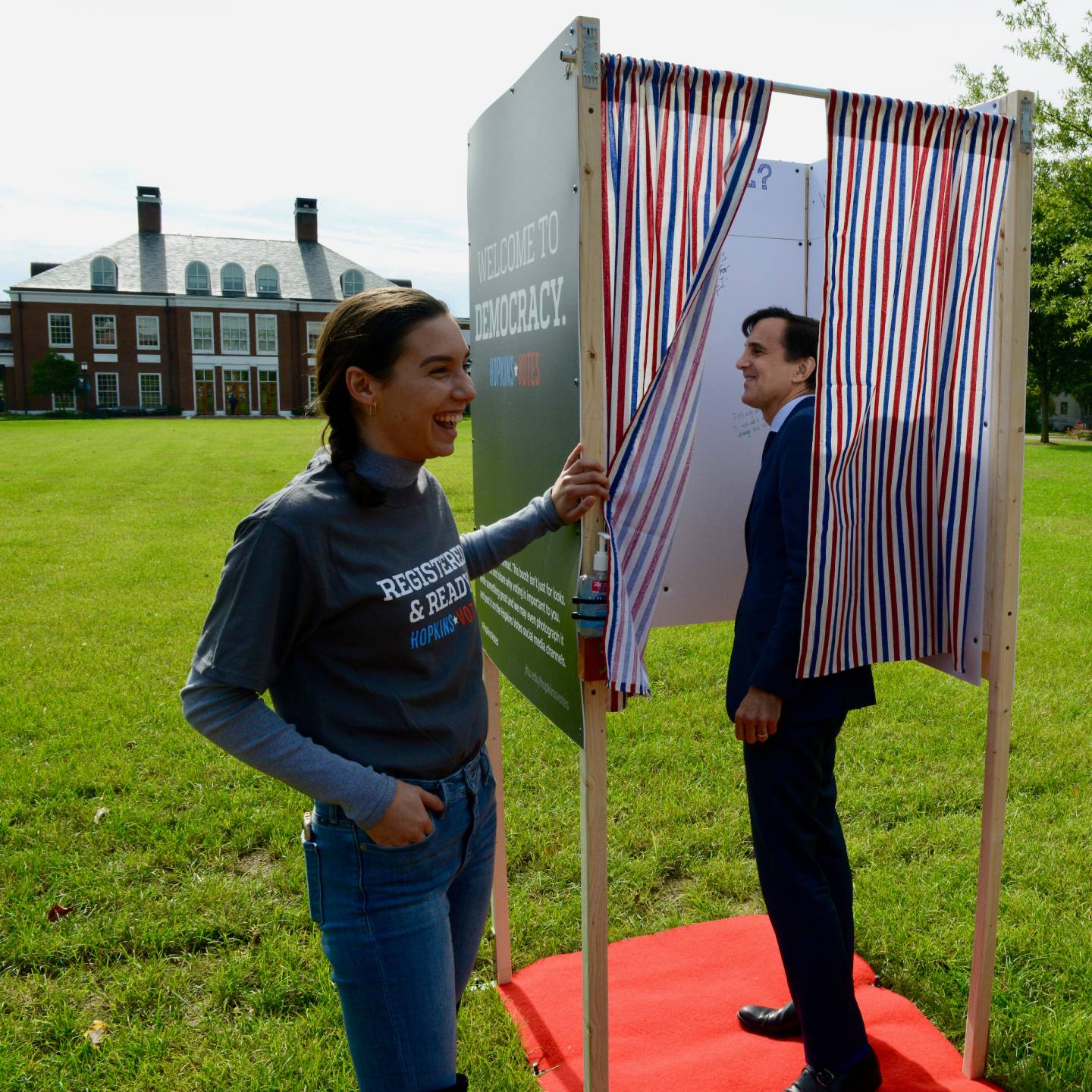 A student and Ron Daniels interact with the voter booth