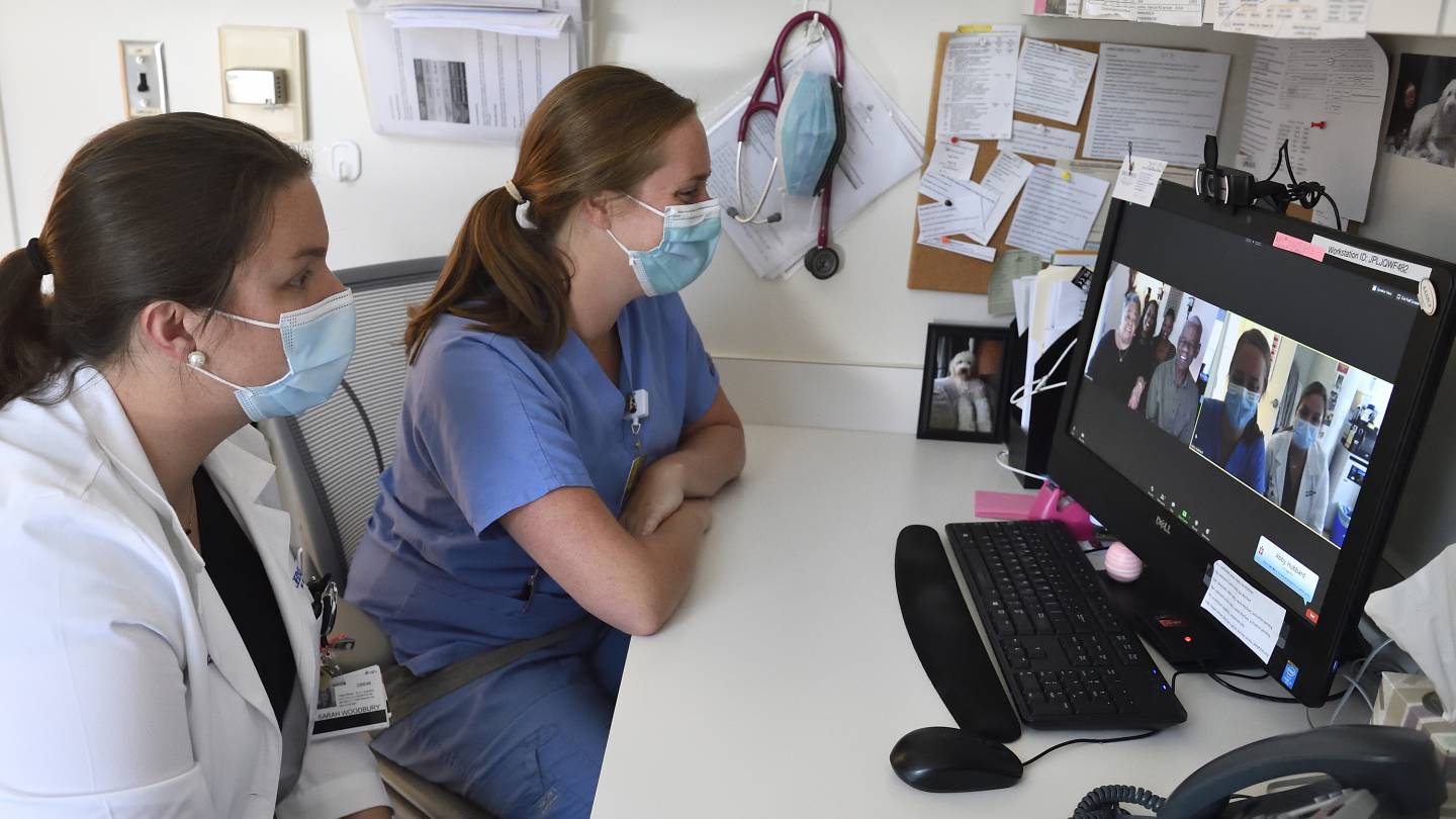 Nurses consult with a family over a video chat