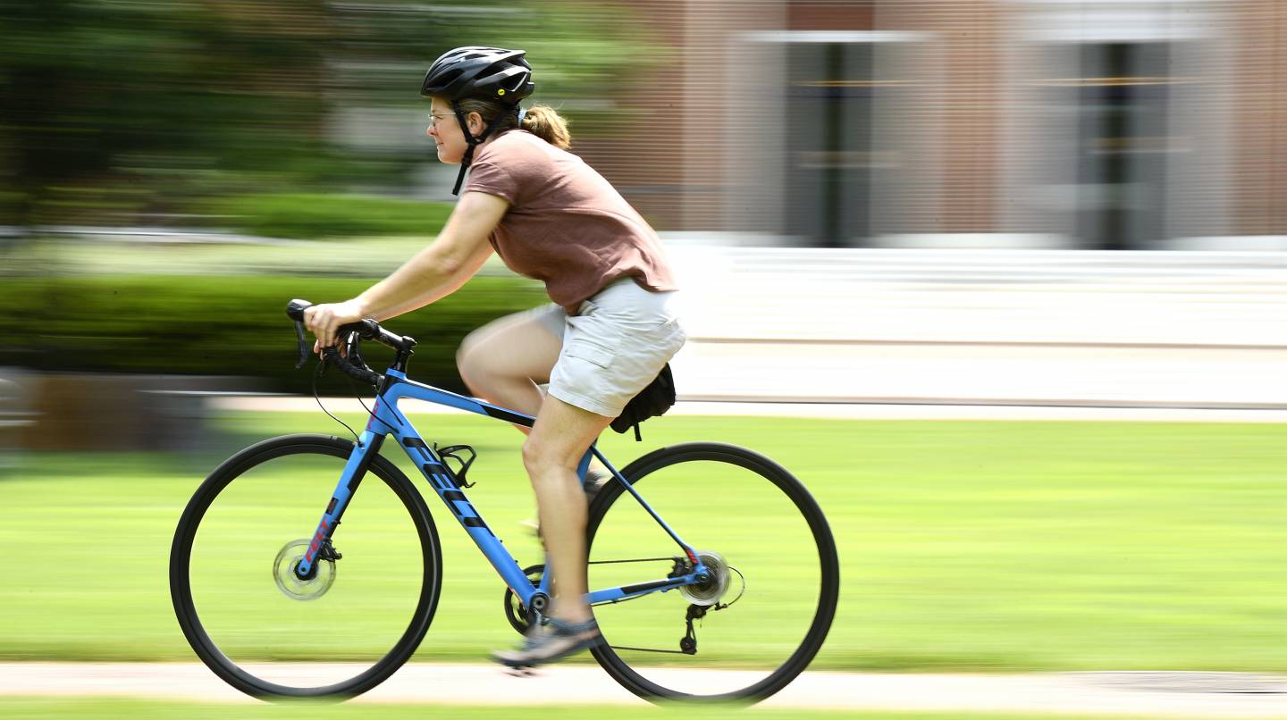 Orla Wilson cycles across campus