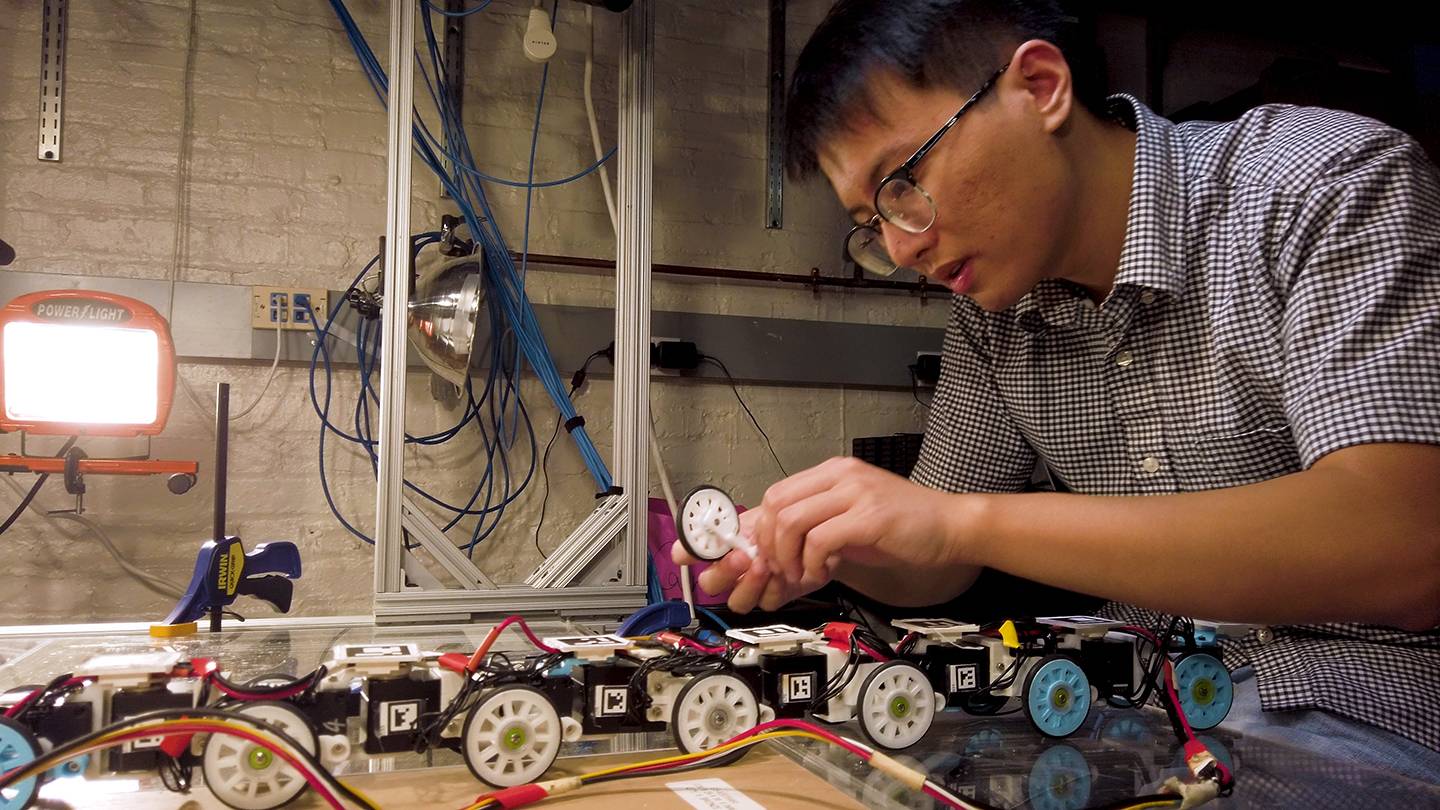 An engineer works on a snake robot