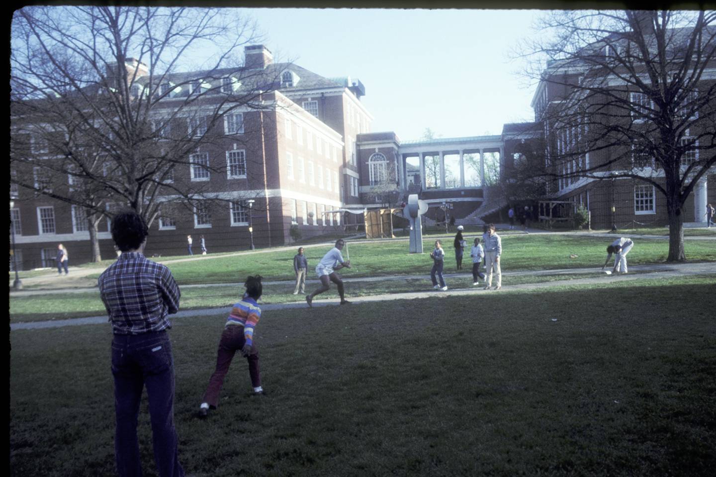 Tutors and students play baseball on Wyman Quad
