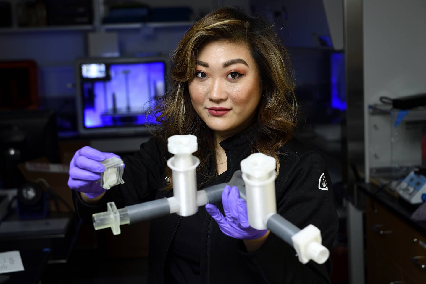 A woman holds a medical device