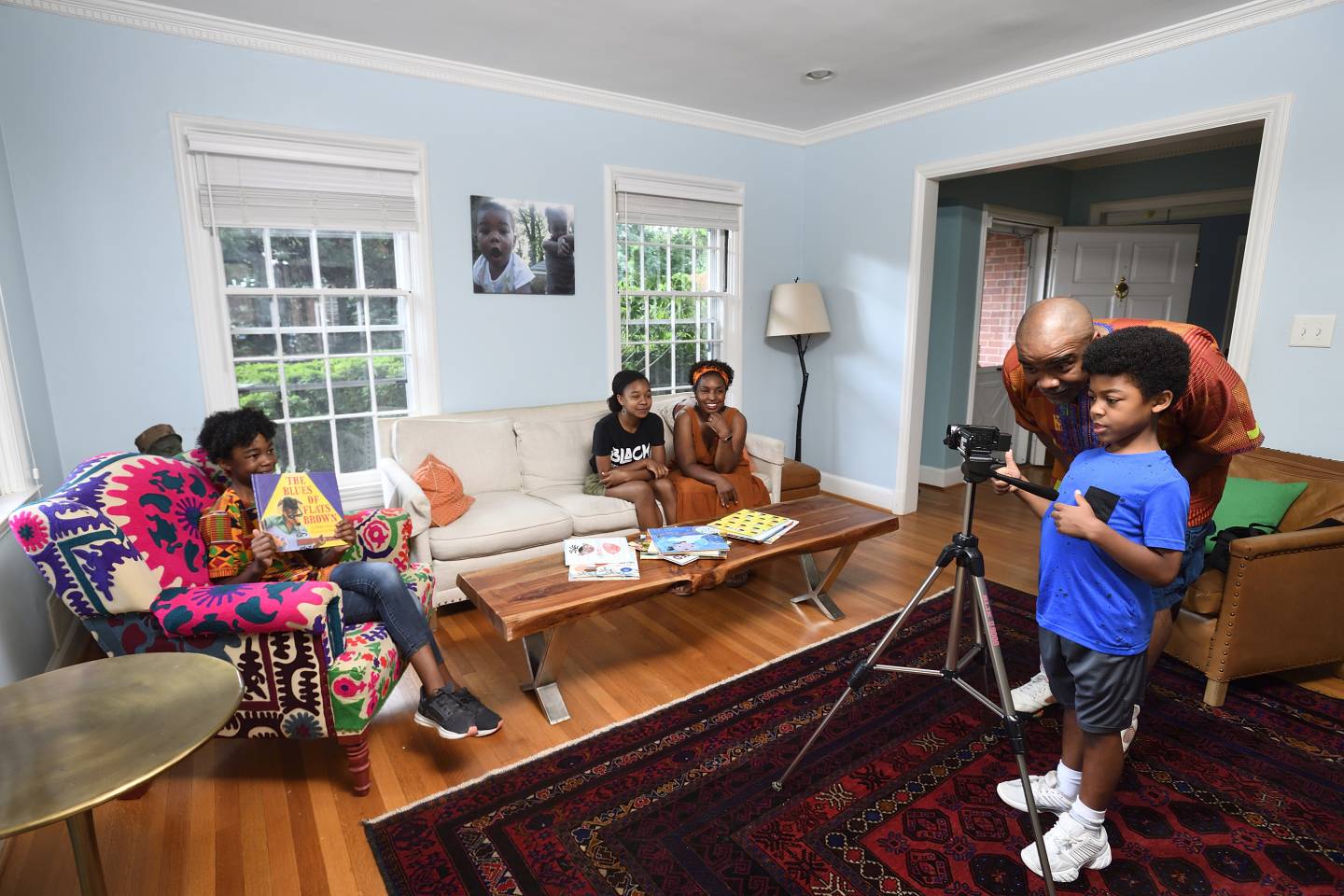 A family records a video in their living room