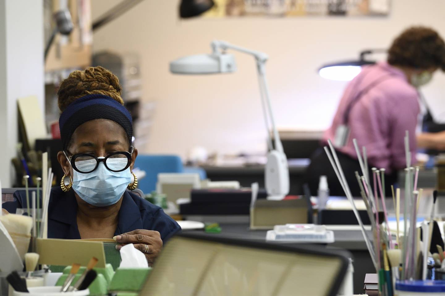 Masked workers resume work in a studio