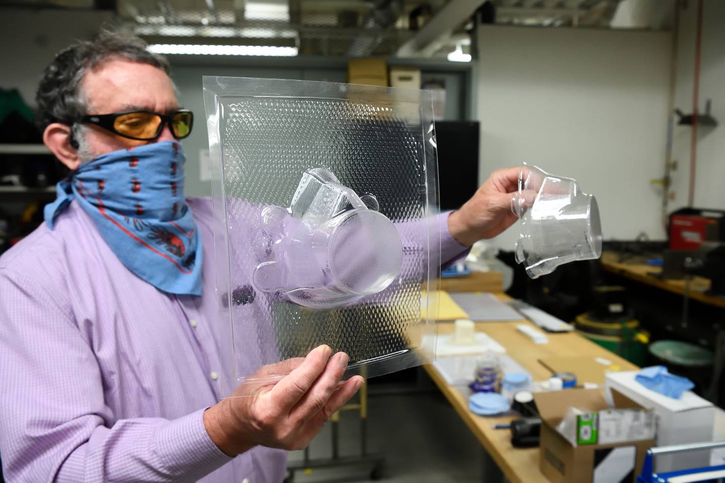Niel Leon examines vacuum-formed pieces built for WSE's respirator mask design.