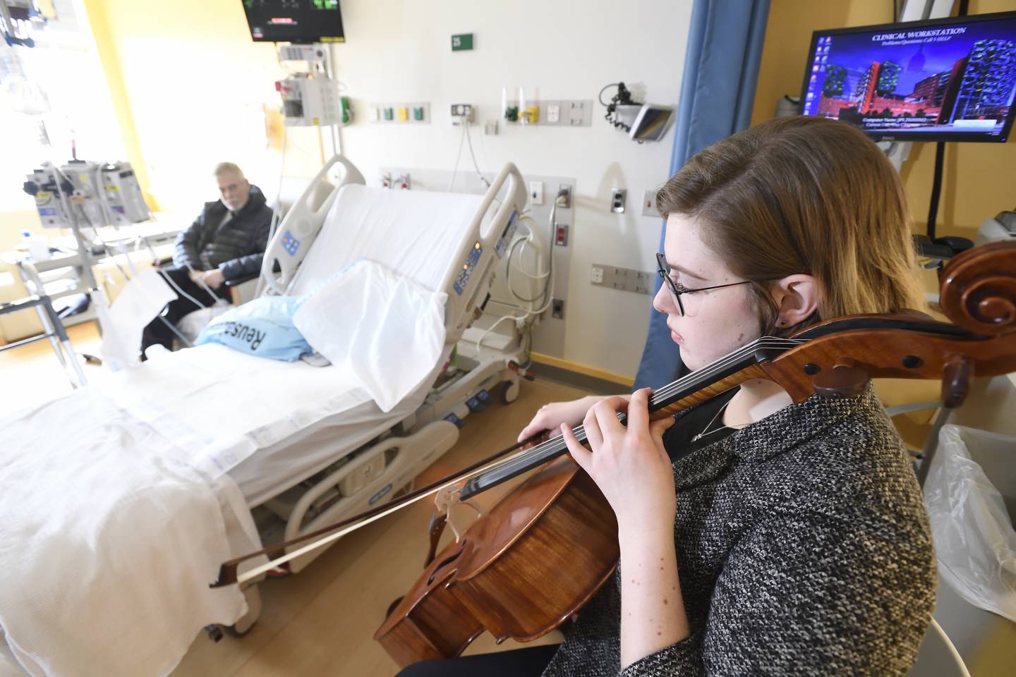 A cellist performs in a hospital room