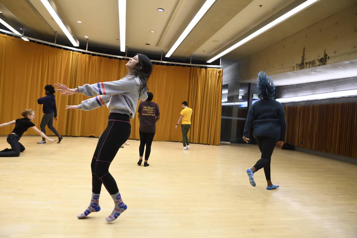 A student smiles while dancing