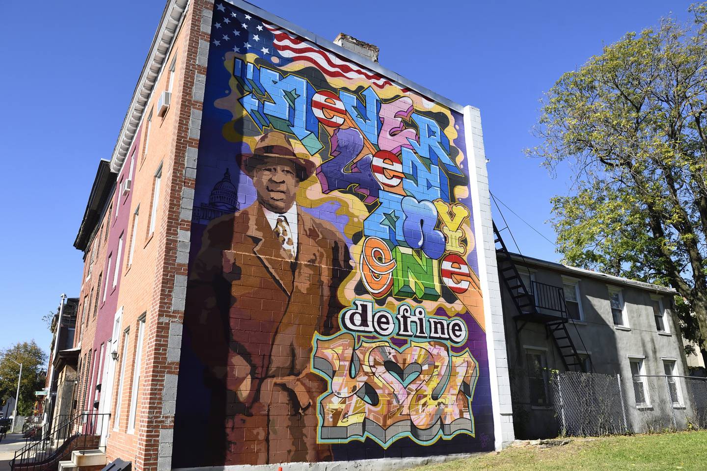 Mural on the side of a row home depicts U.S. Rep. Elijah E. Cummings