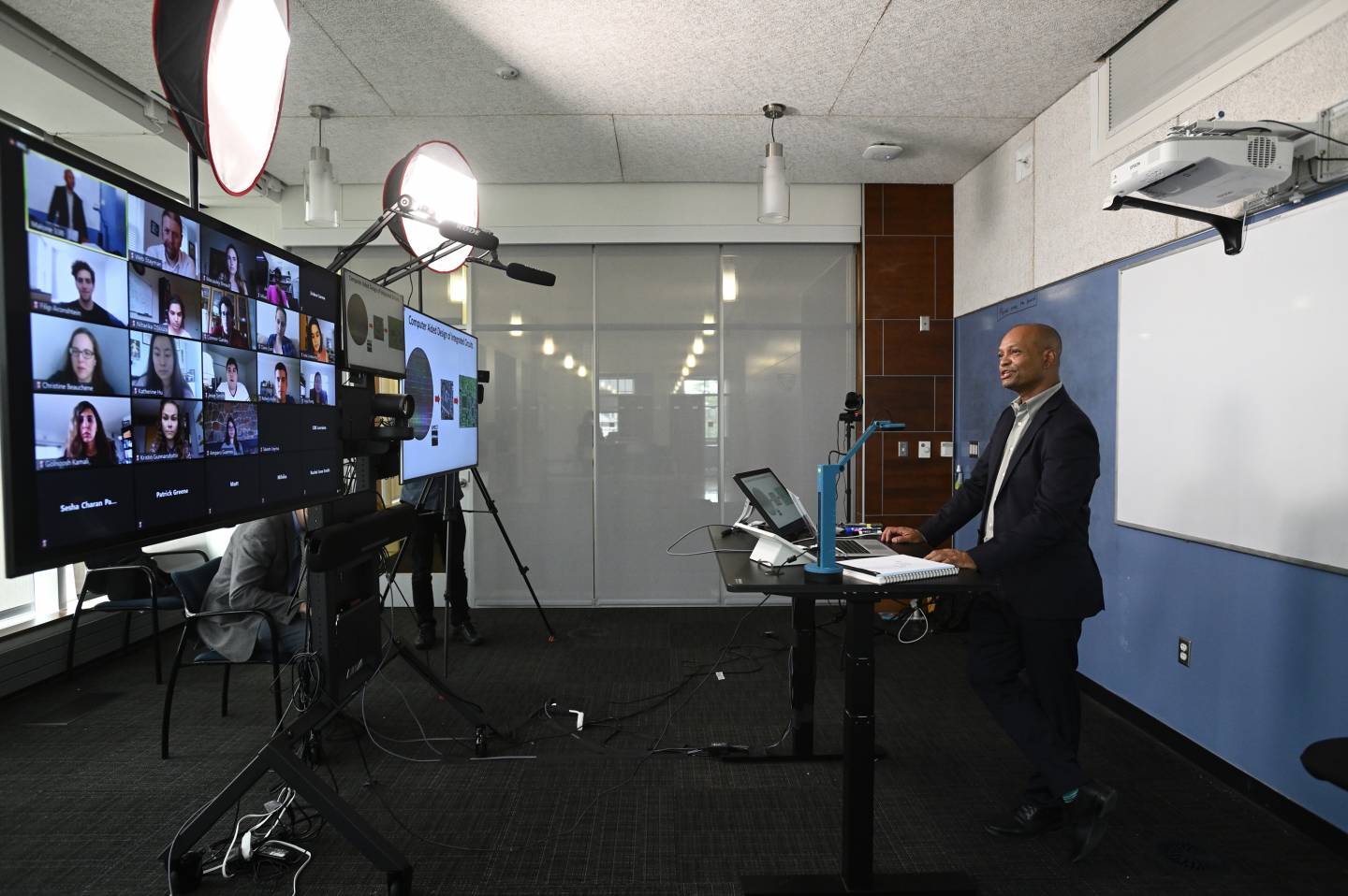 A man teaches a group of students in a dedicated studio space