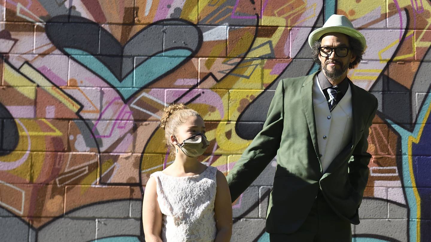 Graffiti writer Adam Stab and his daughter attend the mural unveiling in West Baltimore