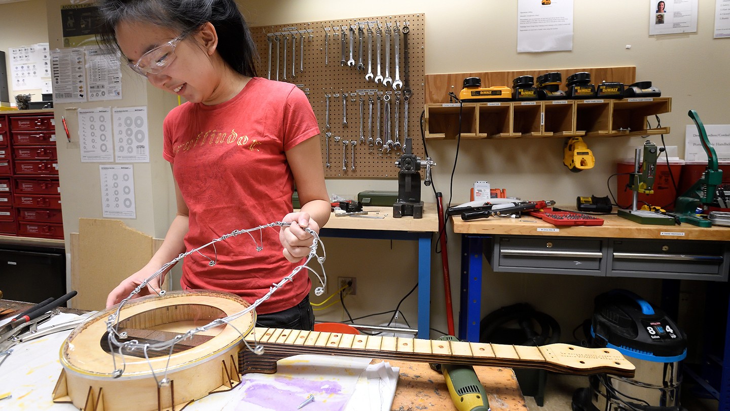 A student builds her banjo