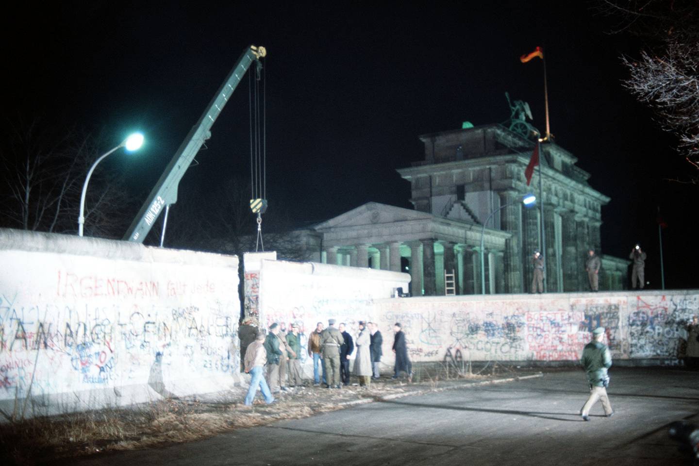 A crane removes a section of the Berlin Wall