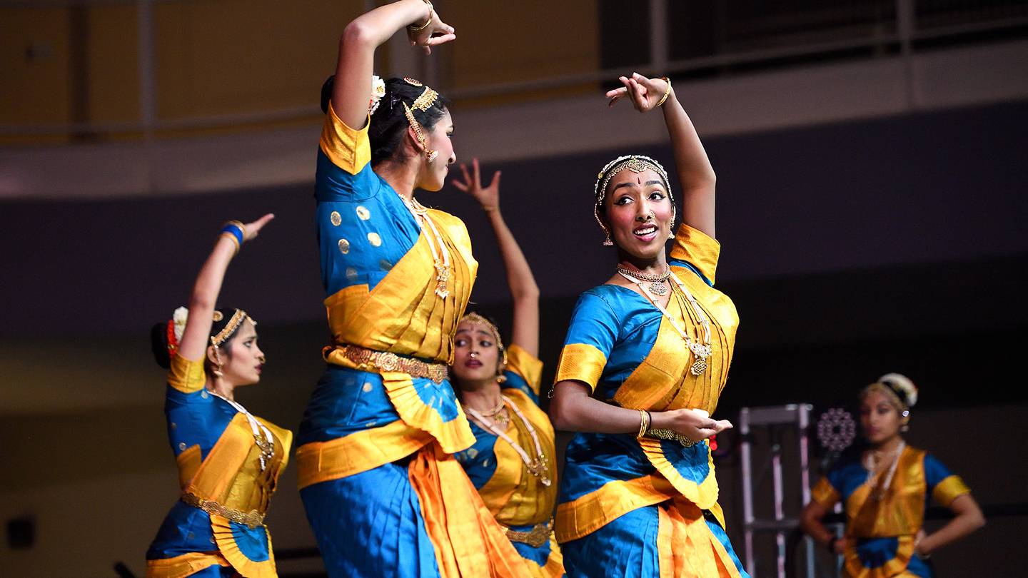 Students in saris perform a synchronized dance Students in saris perform a synchronized dance