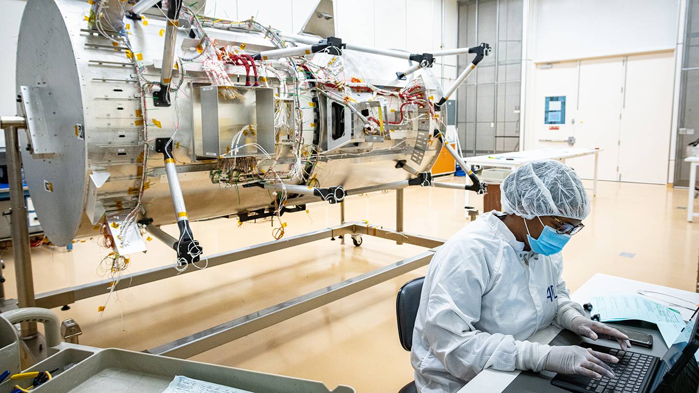 A scientist works on the Europa Clipper spacecraft
