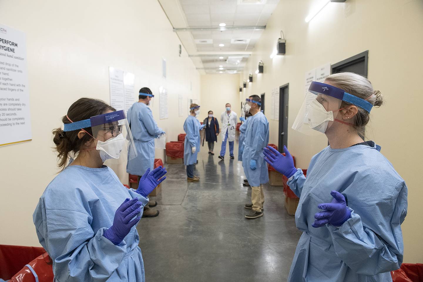 Health workers wear personal protective equipment