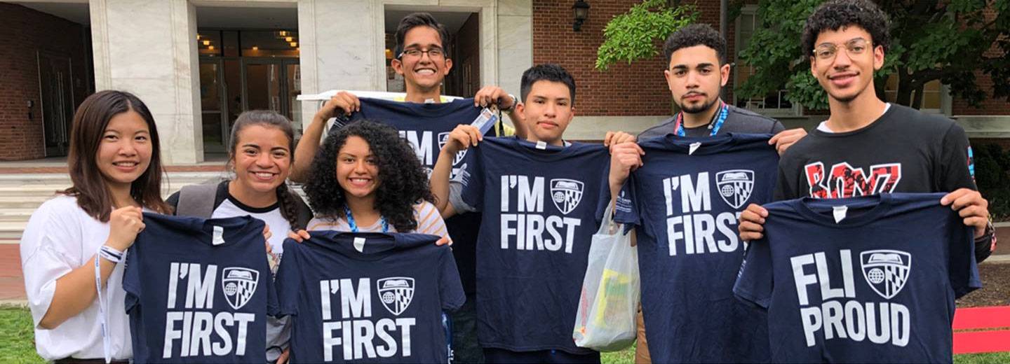Student pose with I'm First t-shirts
