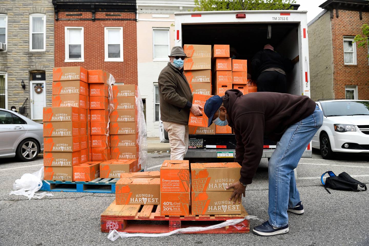 Volunteers deliver boxes of food as part of East Baltimore food distribution initiative