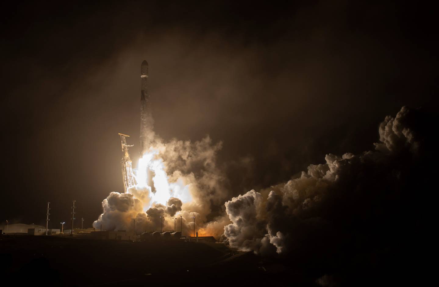 Rocket launches from platform in the dark