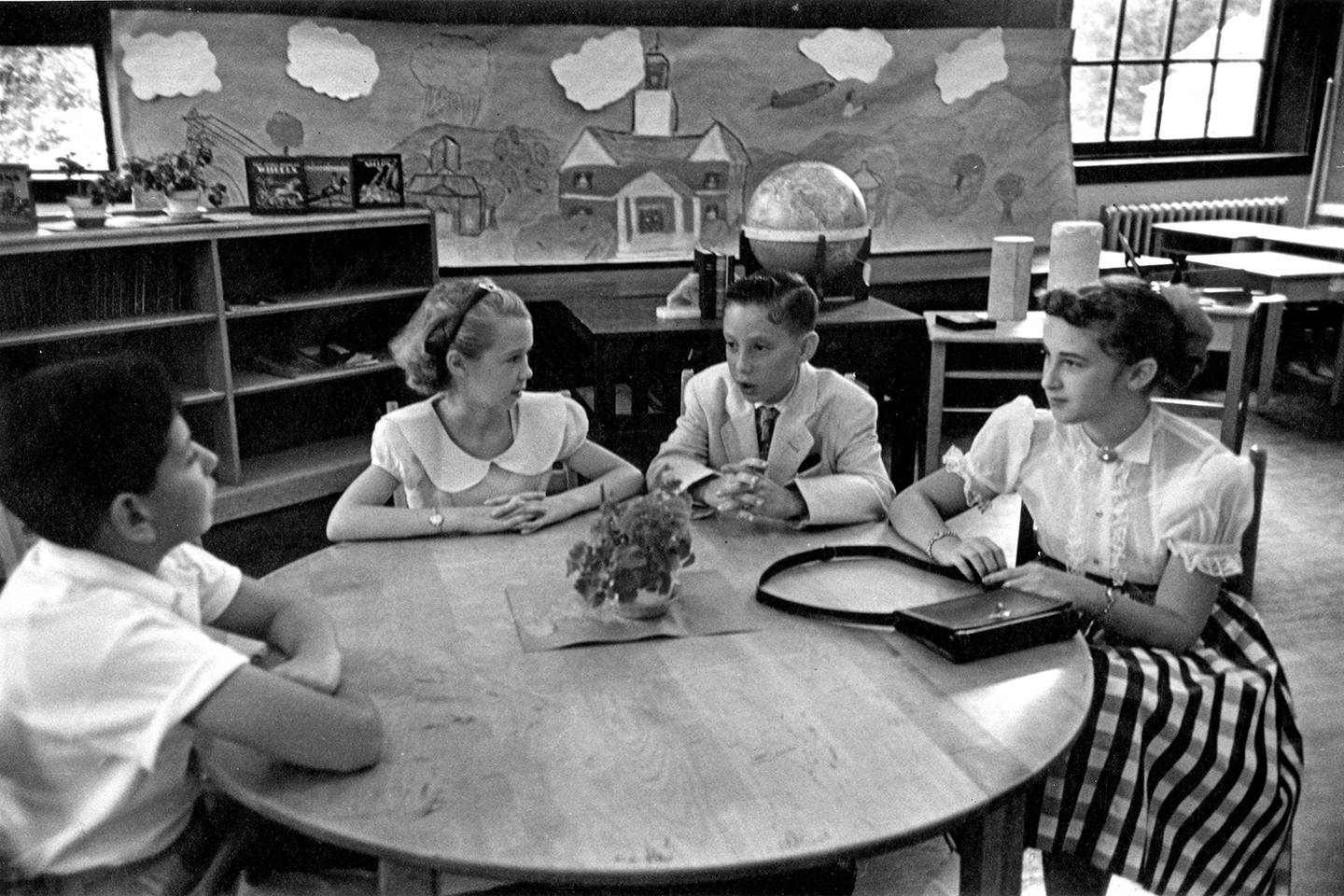 Black and white photo of children on a television set