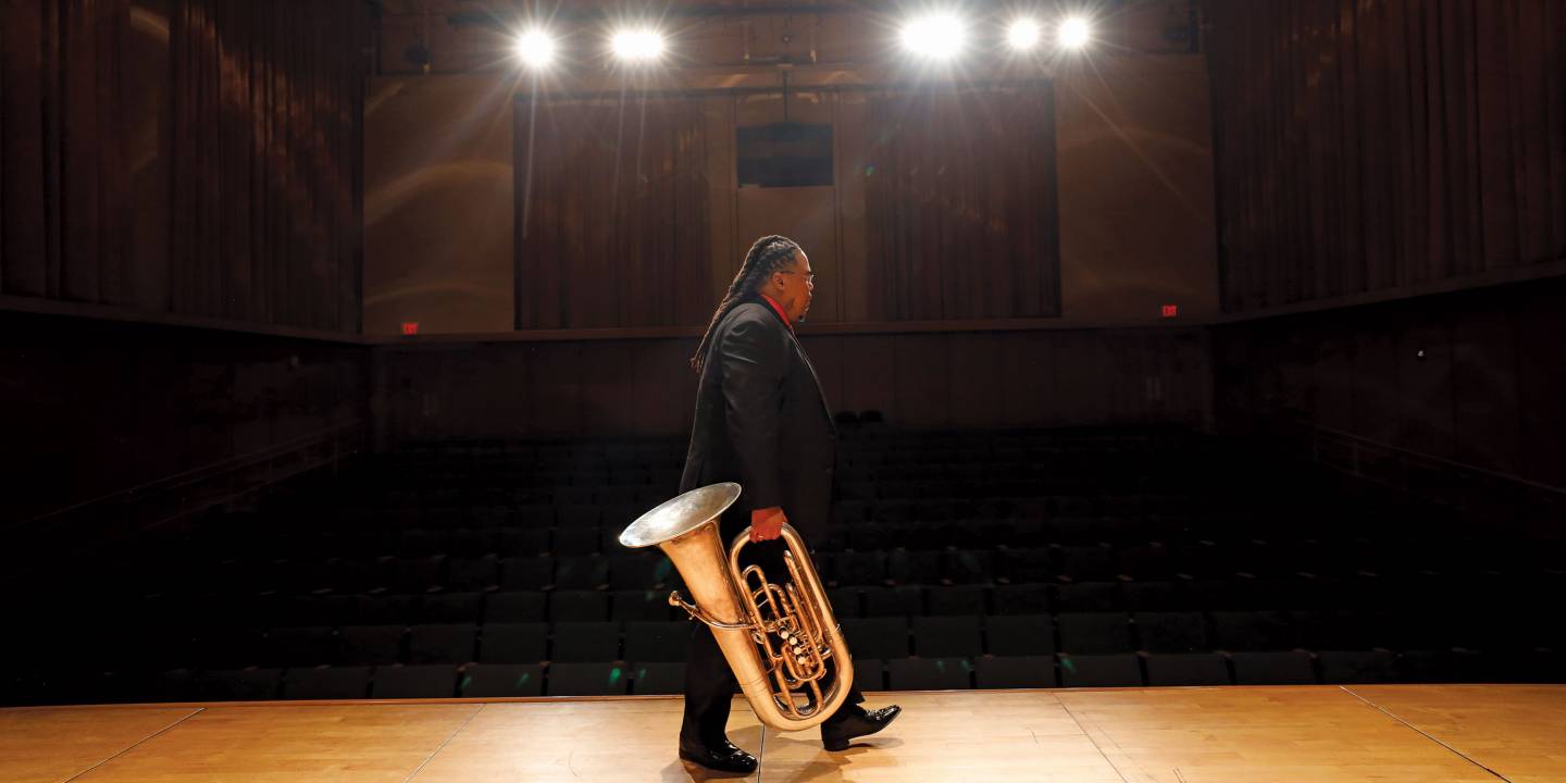 Tubist Richard White walks across stage