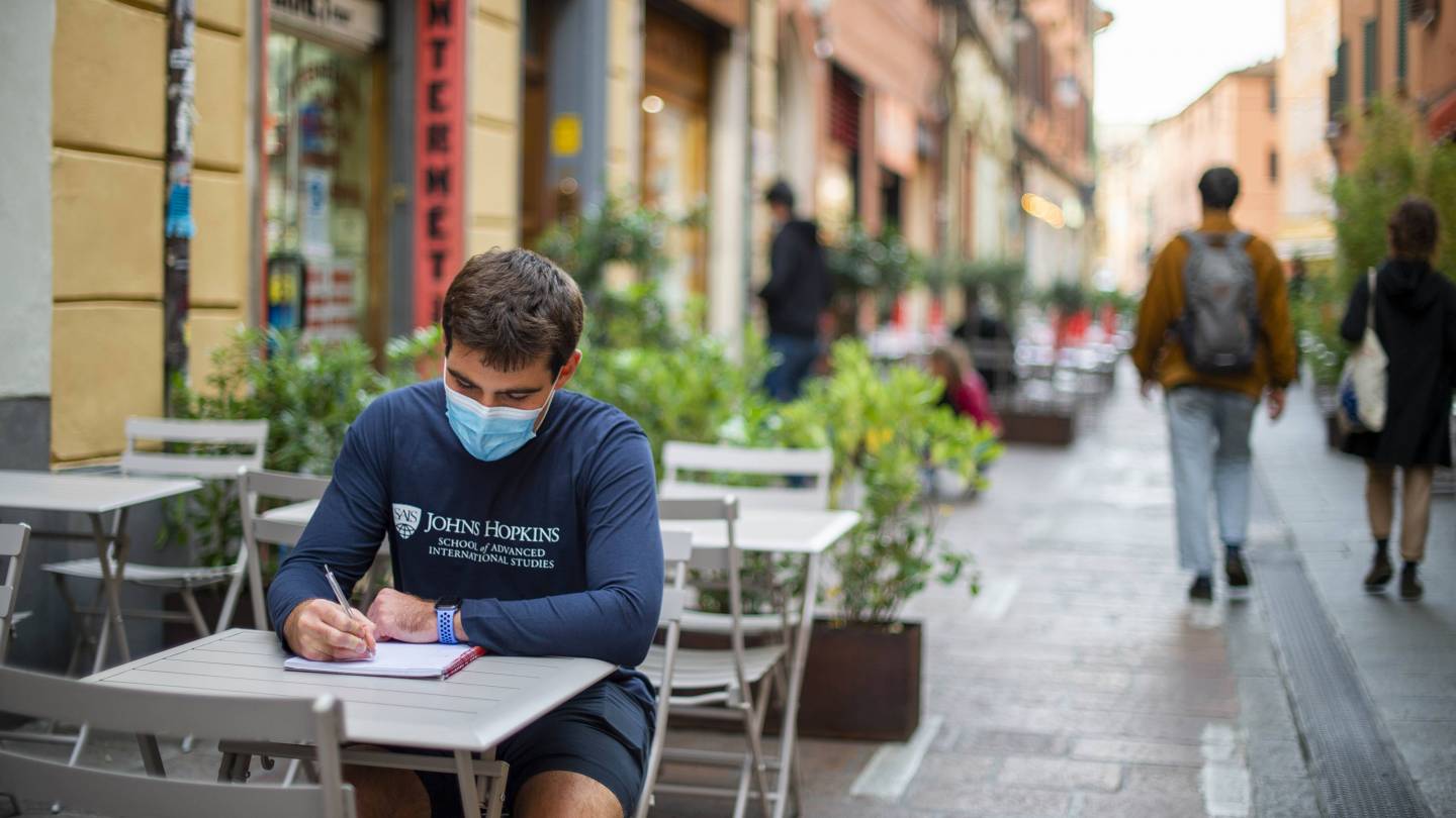 A student studies in a street cafe in Italy