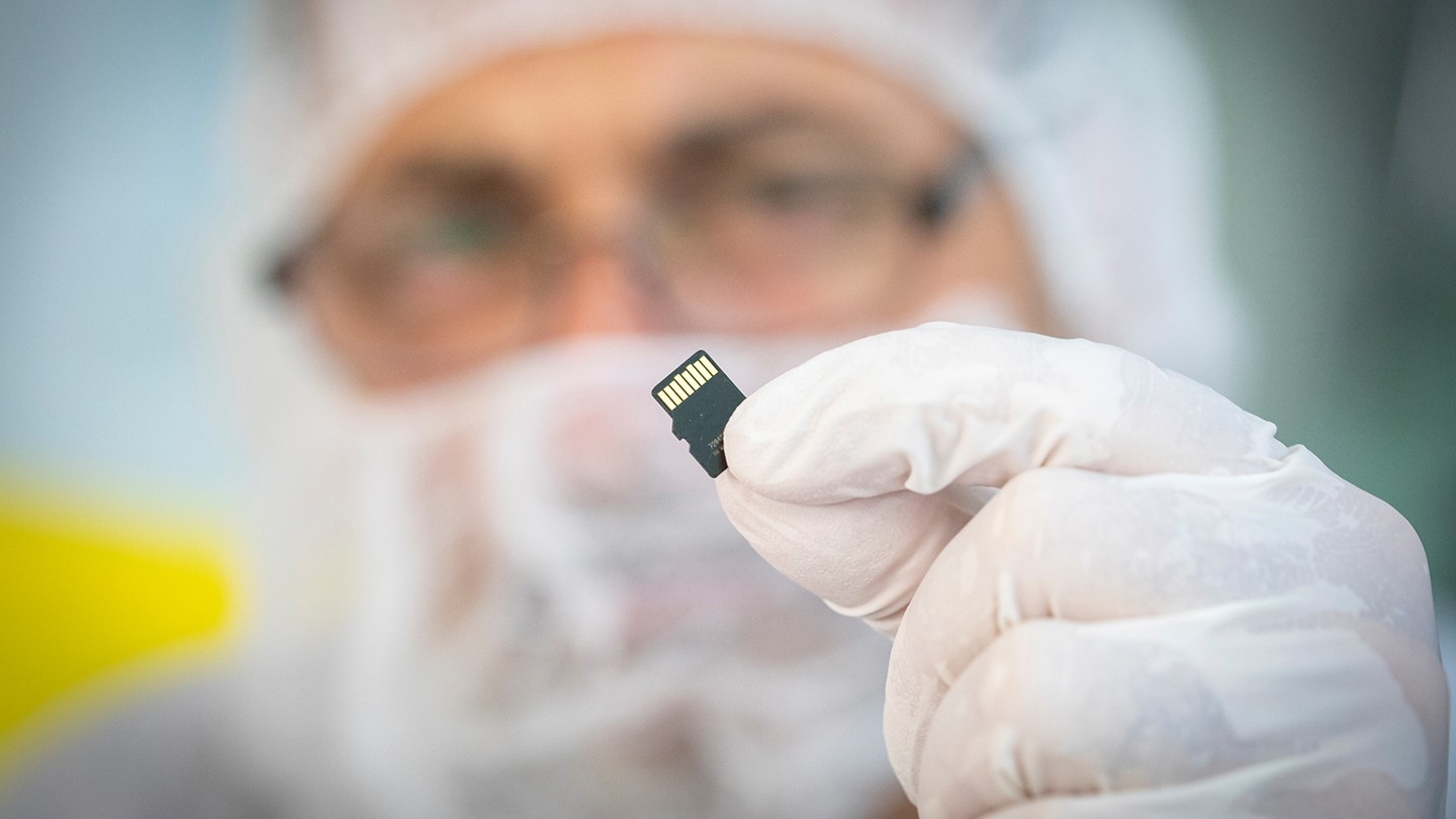 A scientist holds a microchip A scientist holds a microchip