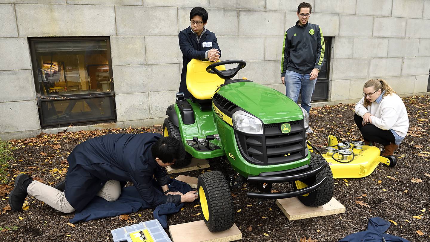 Students work on a tractor