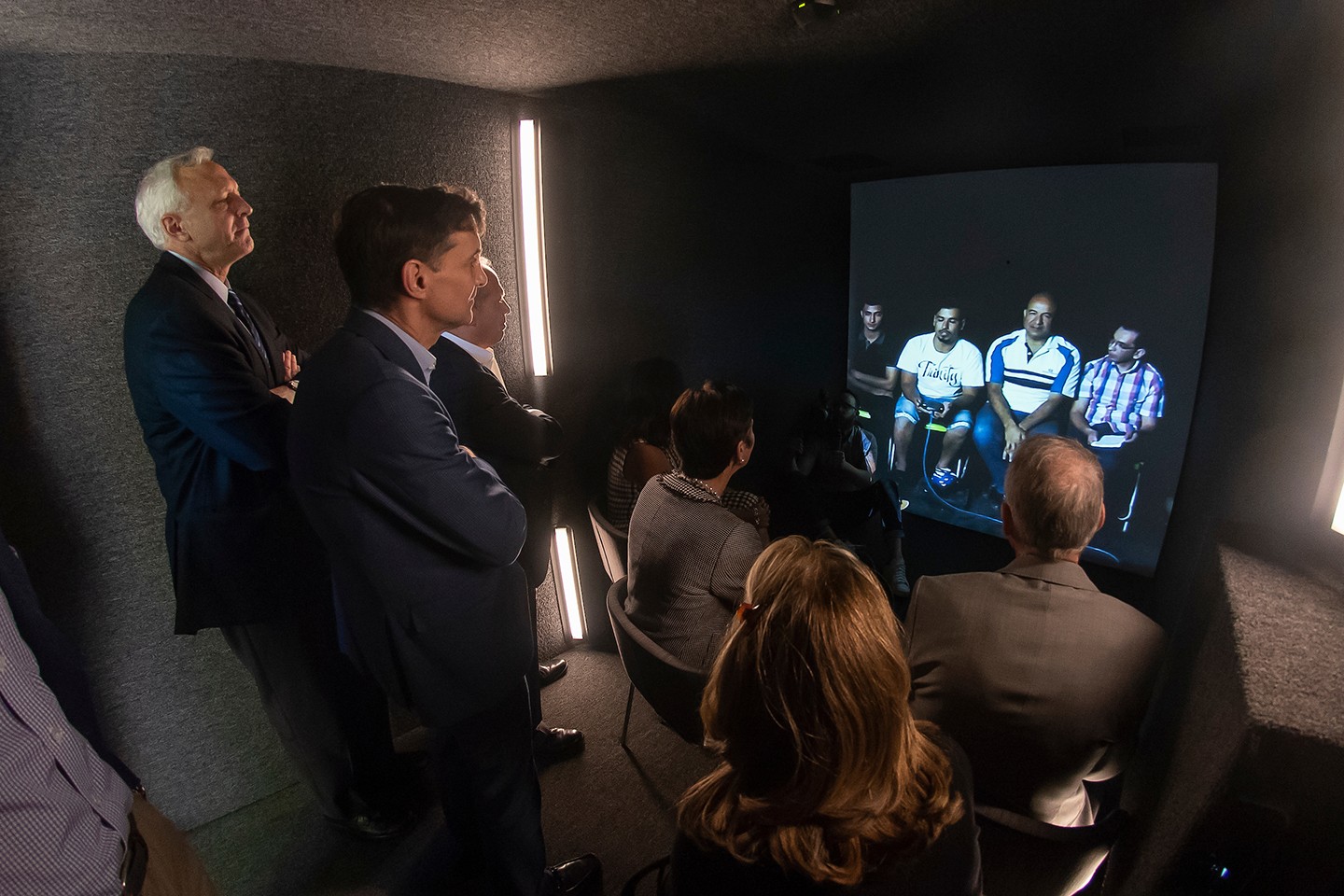President Daniels and trustees stand in front of a screen President Daniels and trustees stand in front of a screen