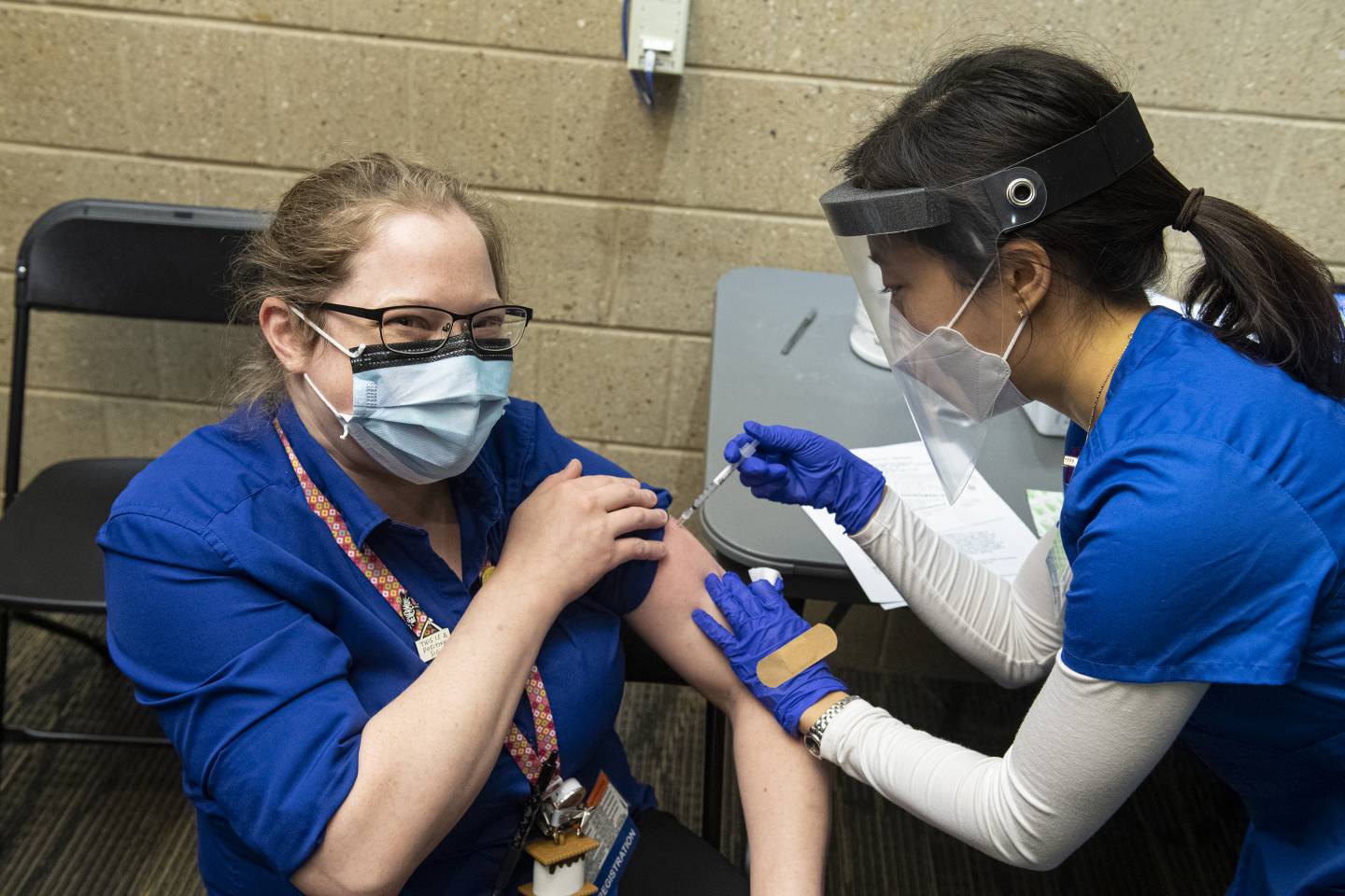 A health care worker is vaccinated